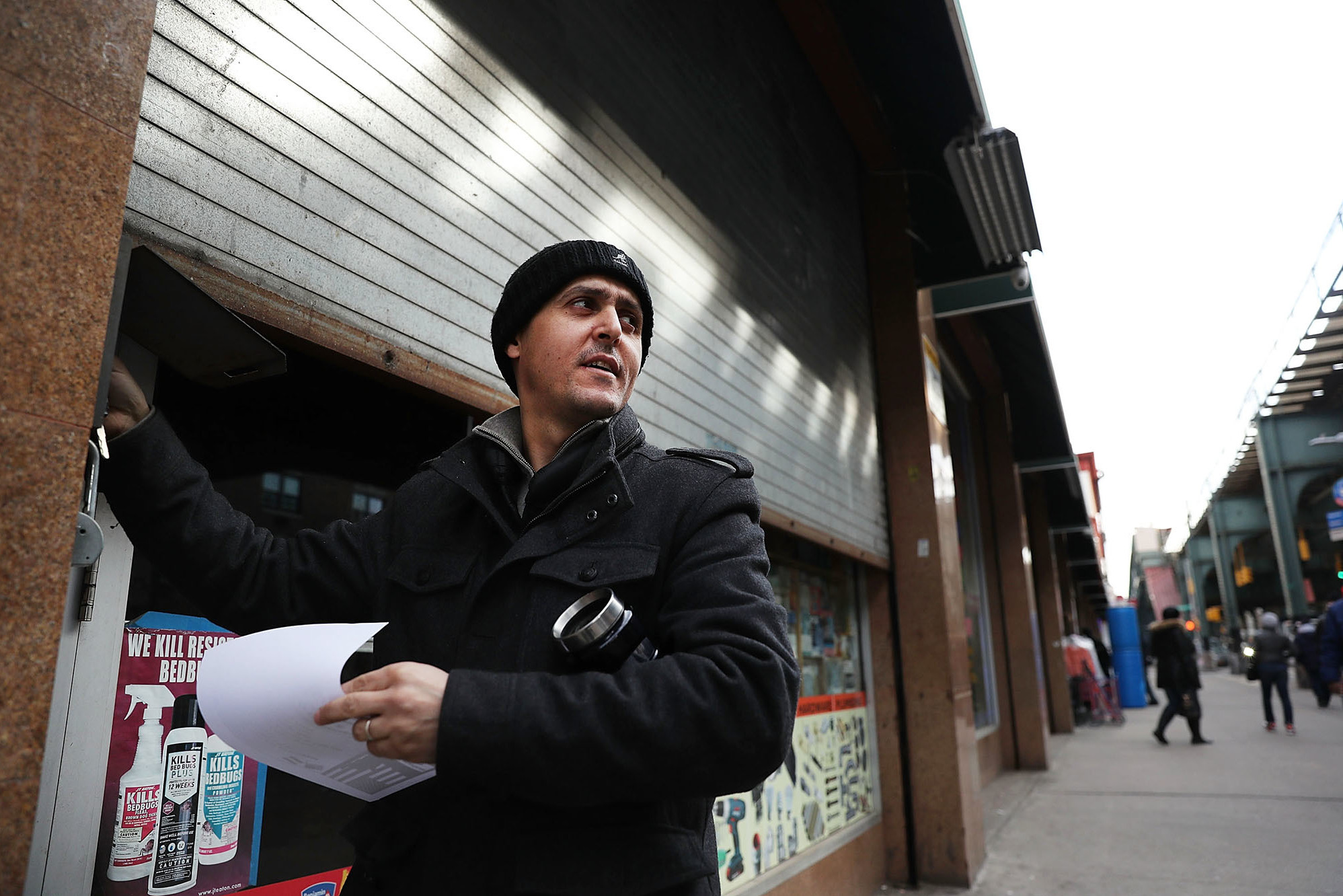 A Yemeni business owner closes the gate to his store Thursday in the Brooklyn borough of New York City. Across the city, Yemeni-owned bodega and grocery stores will shut down from noon to 8 p.m. to protest President Trump's executive order banning immigrants and refugees from seven Muslim-majority countries, including Yemen. (Getty Images)
