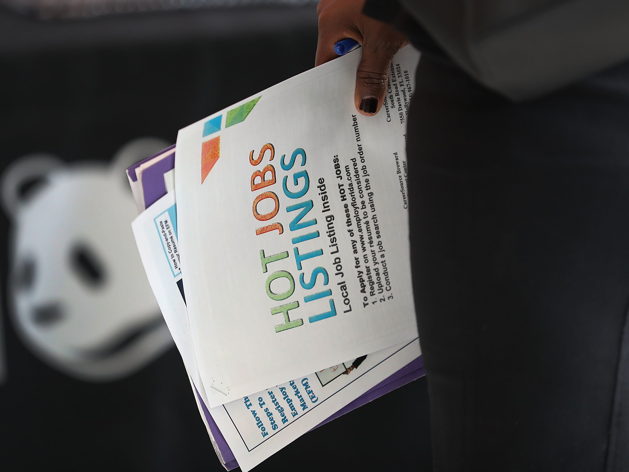 A woman holds a pamphlet announcing jobs listings during the JobNewsUSA job fair at the BB&T Center in Sunrise, Fla., in November 2016. (Getty Images)