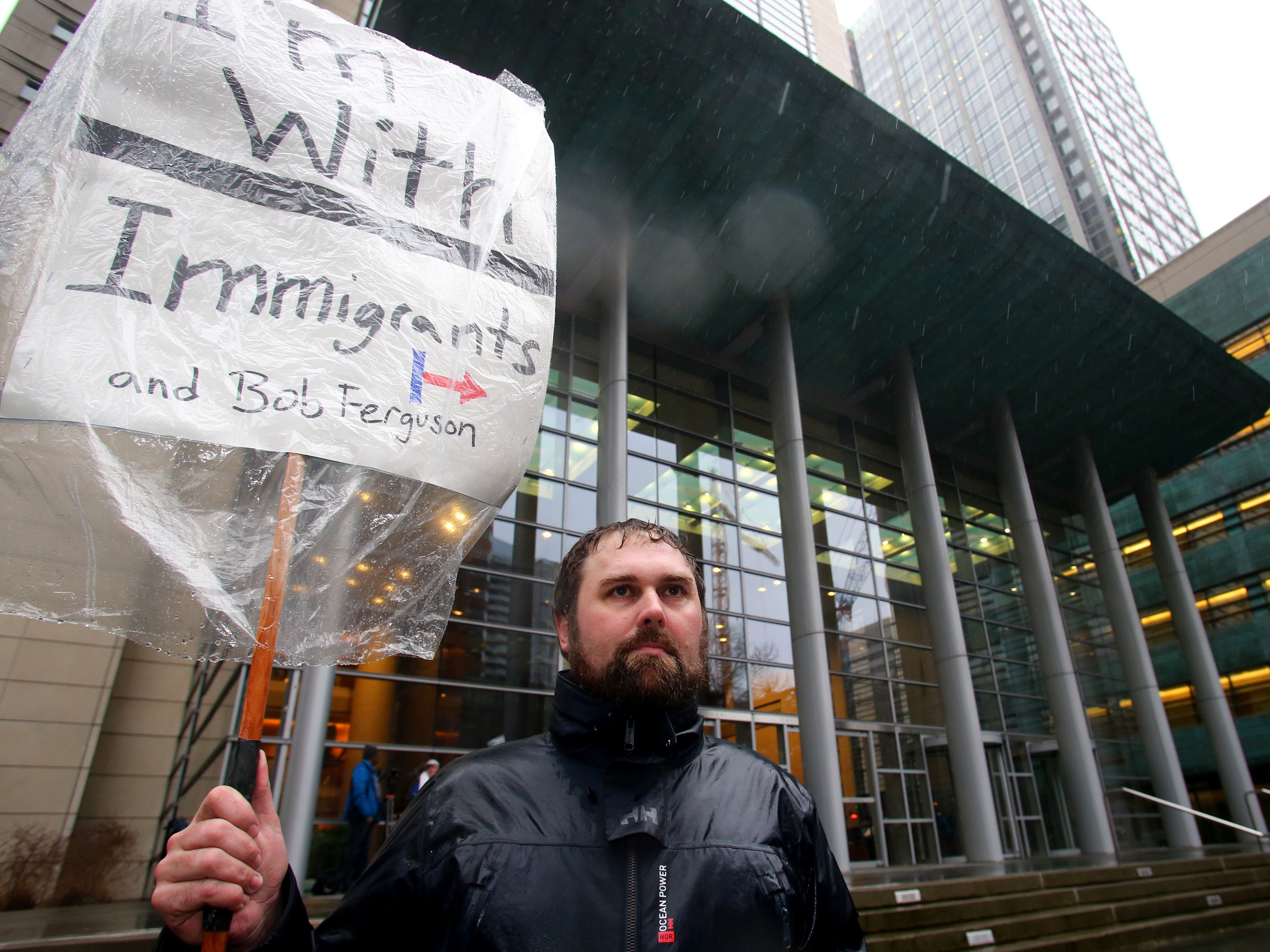 Patrick Wicklund, from Seattle, stands outside the U.S. District Court, Western Washington, on Feb. 3 in Seattle. Washington state Attorney General Bob Ferguson filed a state lawsuit challenging key sections of President Trump's immigration executive order as illegal and unconstitutional. (Getty Images)