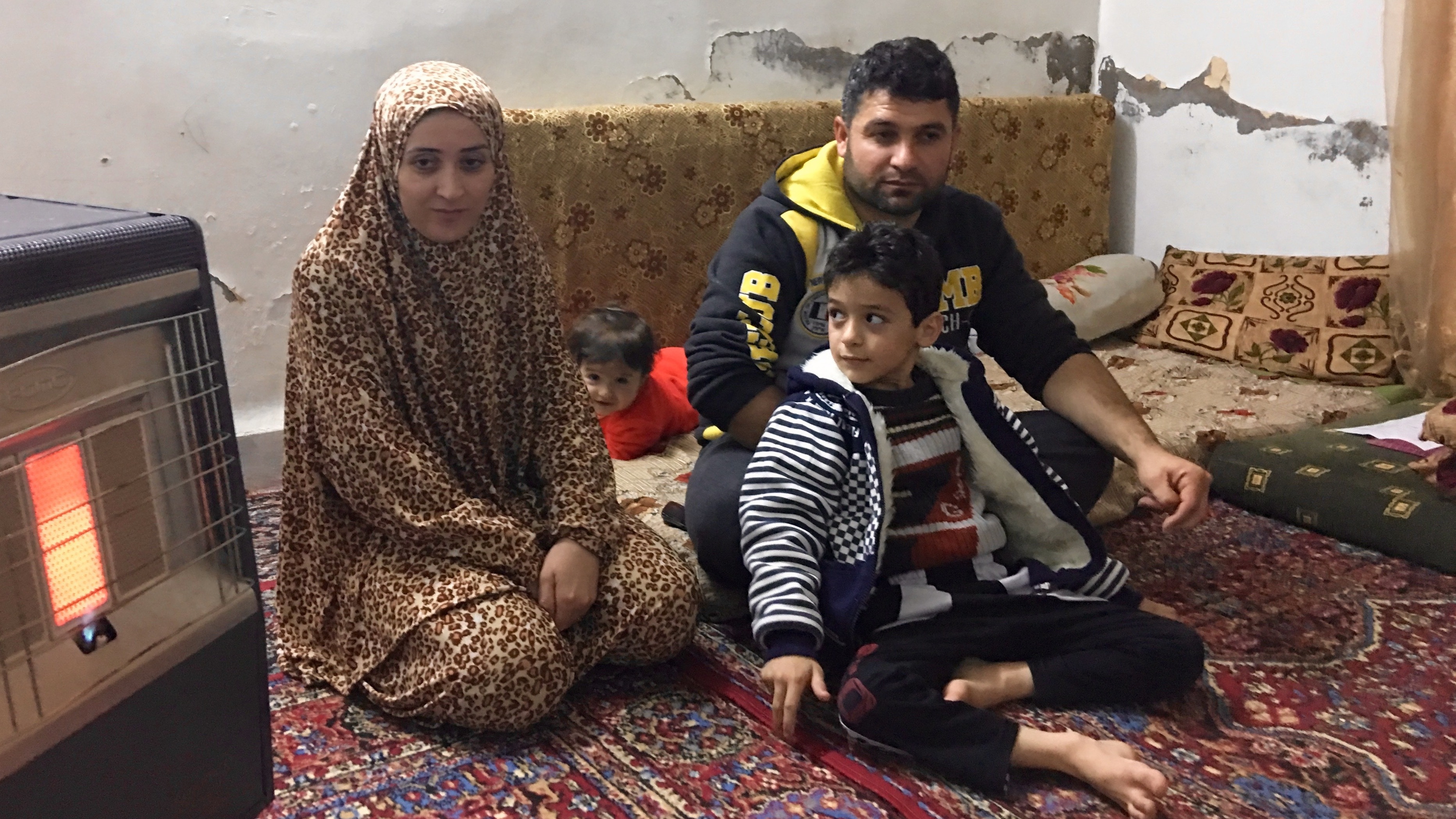 Rafiq al-Saleh, with his wife Ghada Dibo, son Yazan and daughter Elaf at the family's apartment in Zarqa, Jordan. They are among hundreds of Syrian refugees in Jordan who have been in limbo. (NPR)