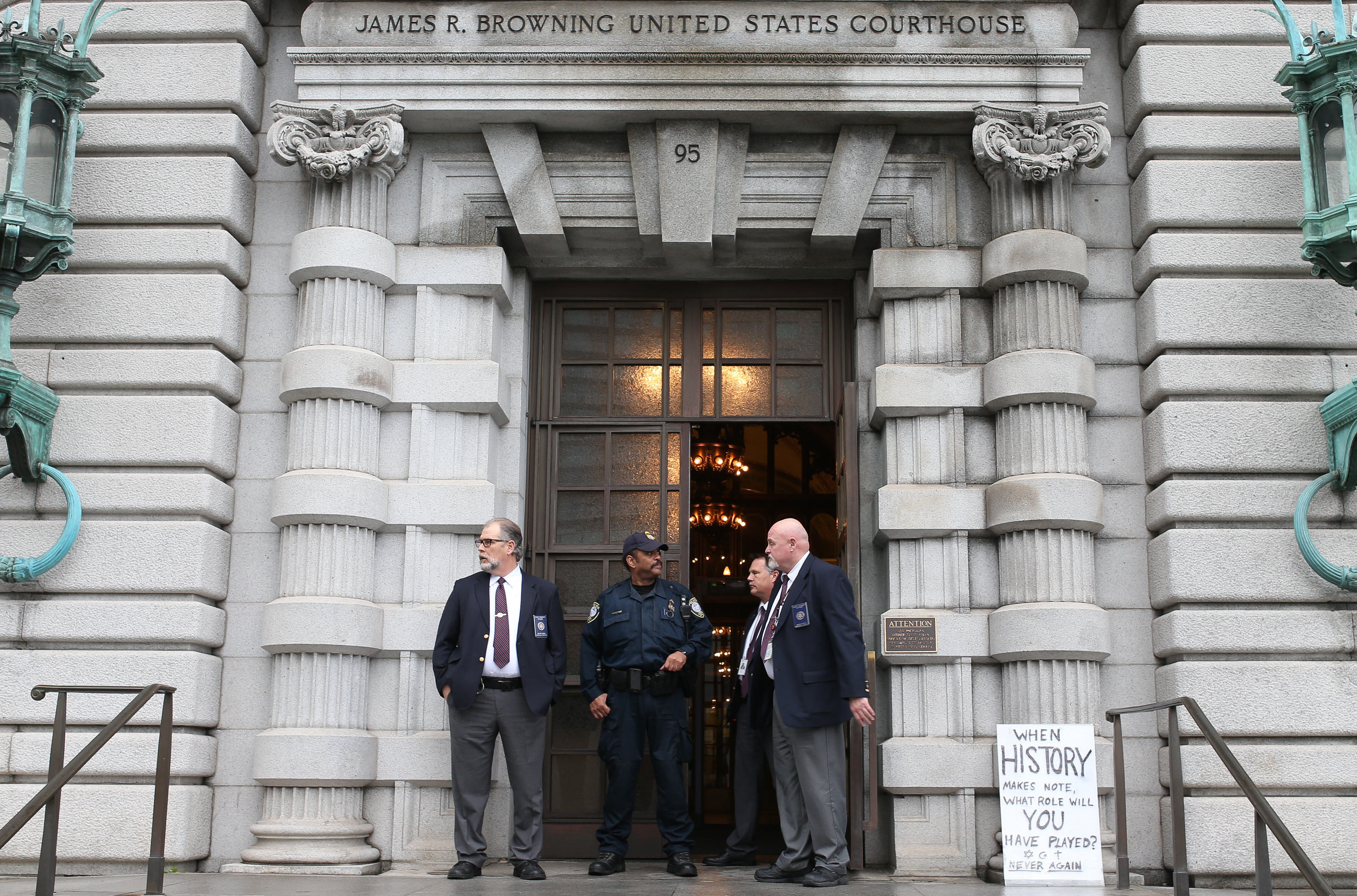 Opponents of President Trump's executive order imposing a temporary immigration ban on seven Muslim-majority nations protest outside a federal appeals court in San Francisco on Tuesday. A three-judge panel heard oral arguments and will now decide whether to lift the stay or leave it in place.
