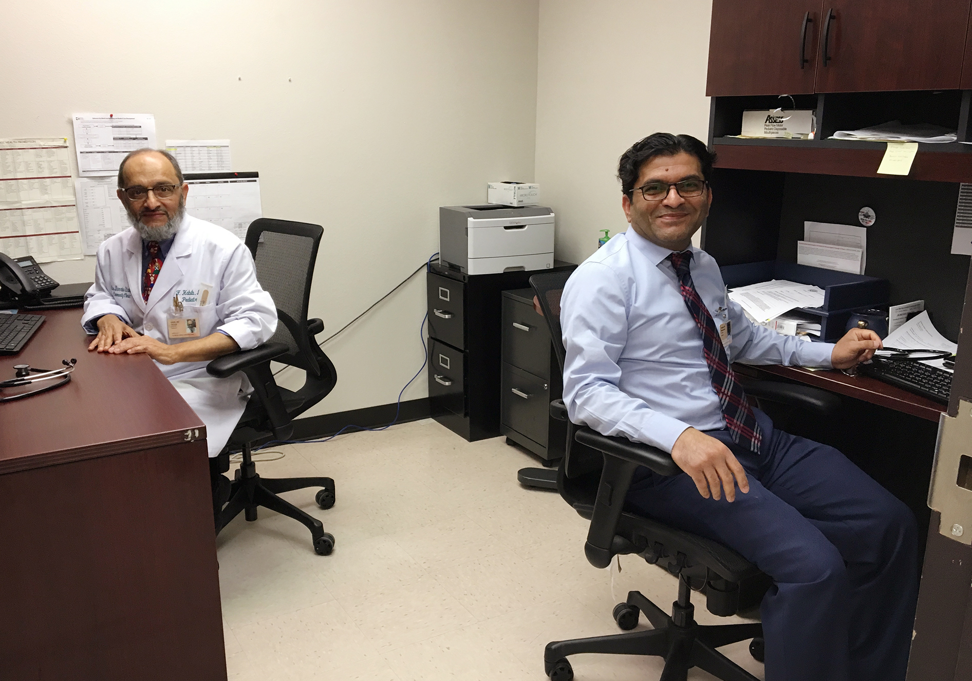 Dr. Farooq Habib (left) and Dr. Muhammad Tauseef share an office at Los Barrios Unidos Community Clinic in Dallas. They're both from Pakistan and have both worked as pediatricians in medically underserved areas in the U.S. (Lauren Silverman/KERA)