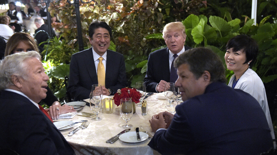 President Trump and first lady Melania Trump (hidden at left) have dinner with Japanese Prime Minister Shinzo Abe and his wife, Akie, at Mar-a-Lago in Palm Beach, Fla., on Feb. 10. Trump said he would personally pay for the visit to his resort . (Susan Walsh/AP)