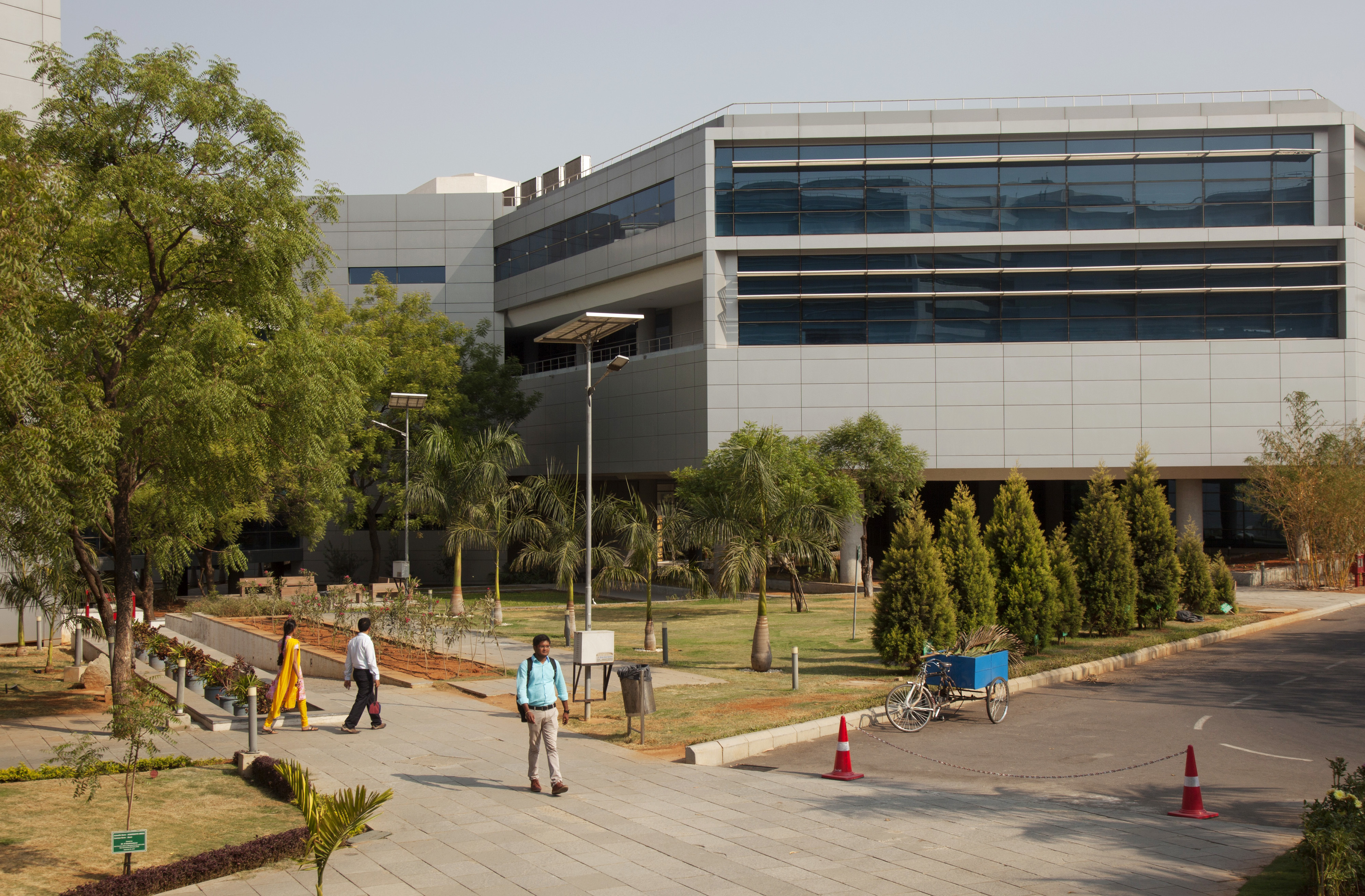 An employee walks along a path at the Tata Consultancy Services Ltd. Synergy Park campus in Hyderabad, India, in 2016. Some in-house PG&E employees will be replaced by workers from TCS. (Bloomberg via Getty Images)