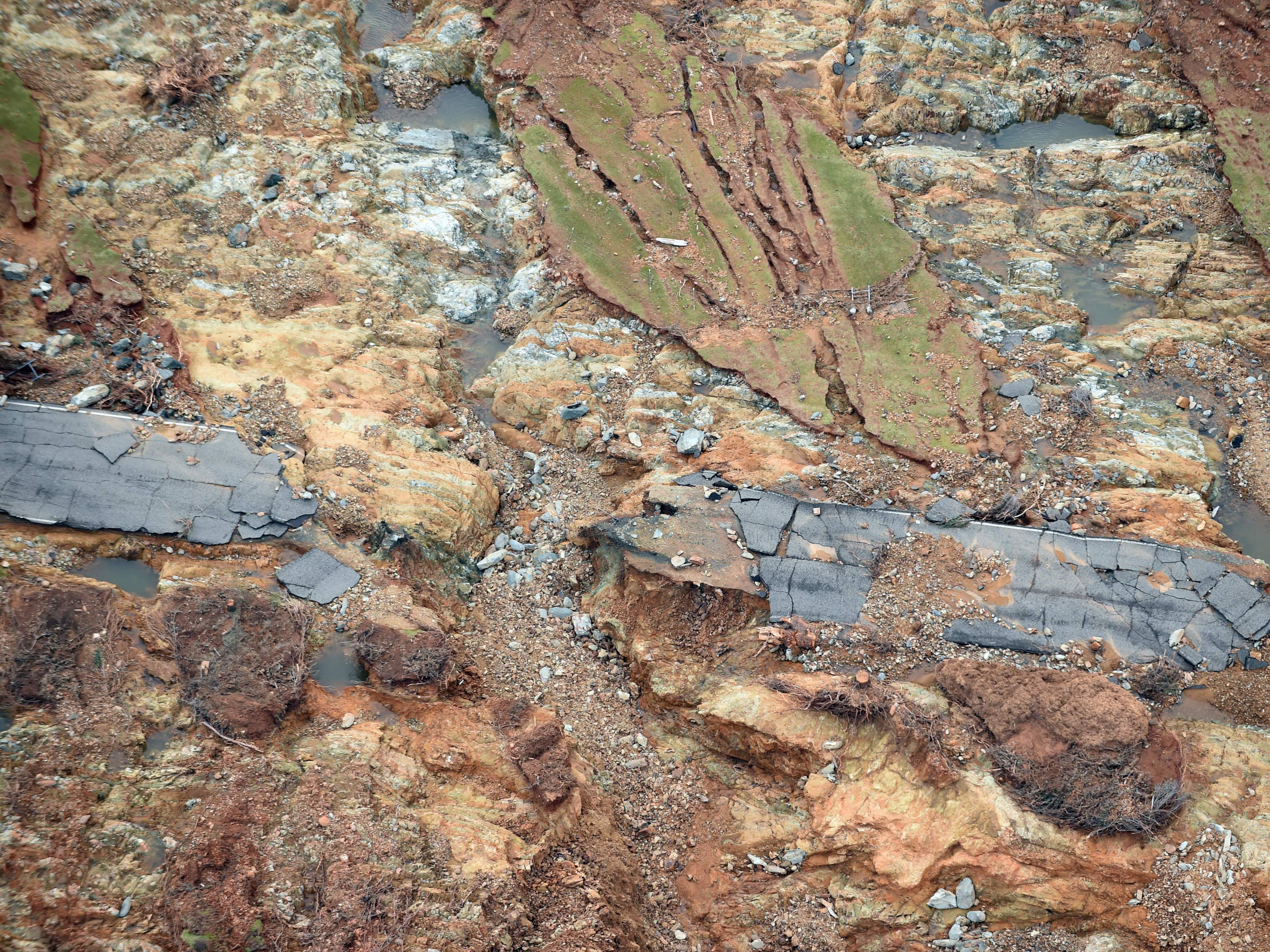 Water released so far by emergency spillways at Oroville Dam in Northern California washed away roadways, eroded the landscape and flooded communities downstream. (AFP/Getty Images)