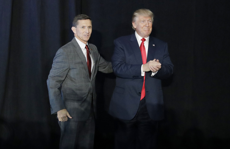 Michael Flynn (left) introduces Donald Trump at a campaign rally on Sept. 29, 2016, in Bedford, N.H. After less than a month on the job, Flynn resigned Monday as President Trump's national security adviser. (John Locher/AP)