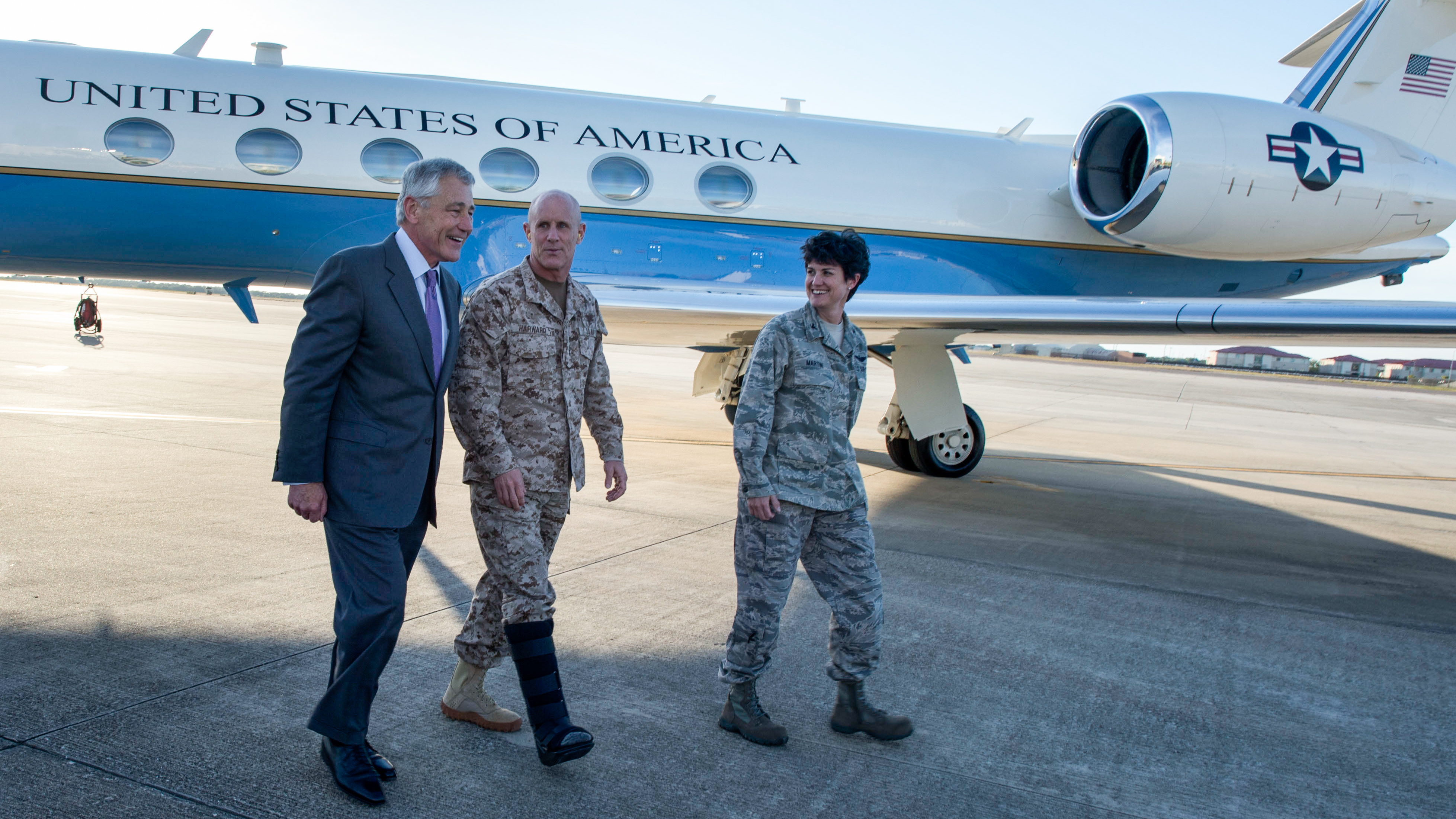 U.S. Secretary of Defense Chuck Hagel (left) walks with Vice Adm. Robert Harward (center), the deputy commander of U.S. Central Command, and Col. Kelly Martin, the vice commander of 6th Air Mobility Wing, after landing at MacDill Air Force Base in Tampa, Fla., in 2013. (DoD)