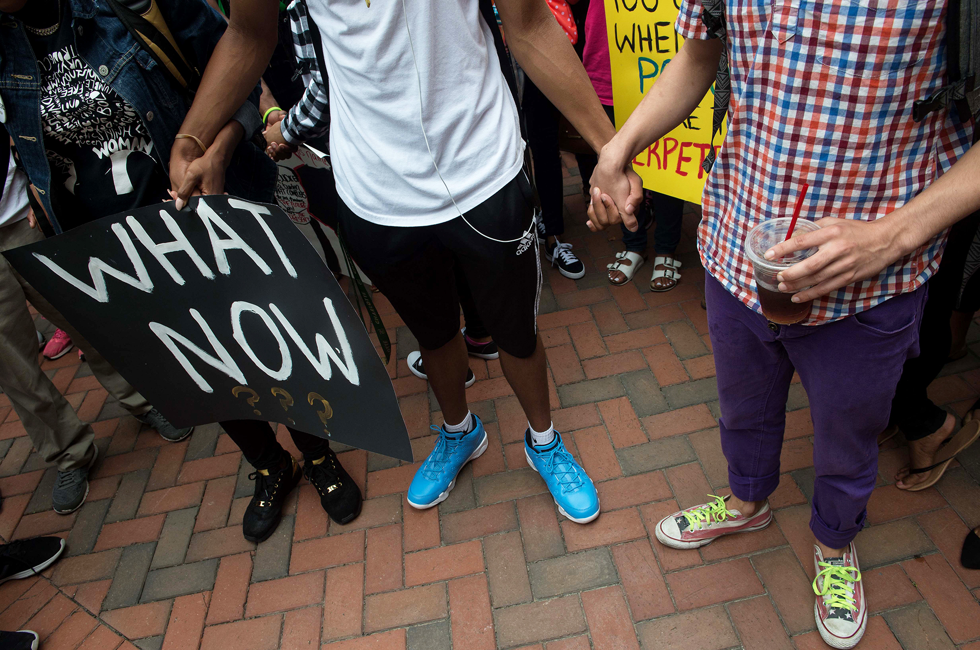 Uncertainty about the future can raise stress levels, psychologists say. Here, students in Charlotte, N.C., hold hands during a Sept. 21 protest after Keith Lamont Scott was shot and killed by a police officer. (AFP/Getty Images)