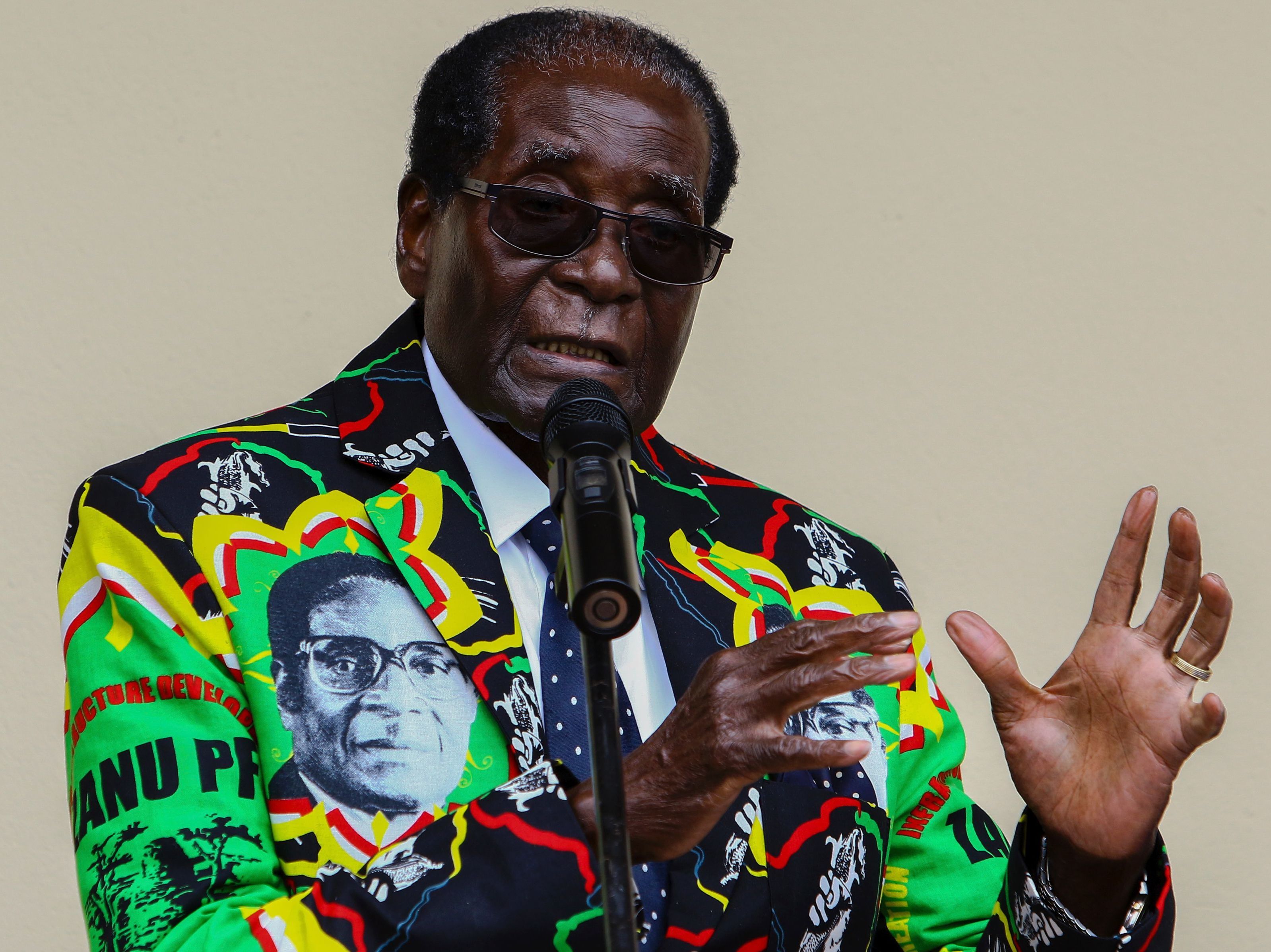 Zimbabwe's President Robert Mugabe, who turns 93 on Tuesday, speaks at his party's annual conference in December, where he was endorsed as a candidate for the 2018 election. His wife said last week that even if he dies before the election, he should run &quot;as a corpse.&quot; (AFP/Getty Images)