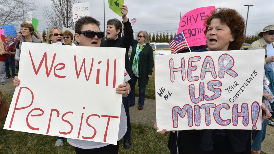 A group numbering in the hundreds gather to protest the appearance of Senate Majority Leader Mitch McConnell R-Ky., and the policies of the Trump administration in Jeffersontown, Ky., on Wednesday. (Timothy D. Easley/AP)