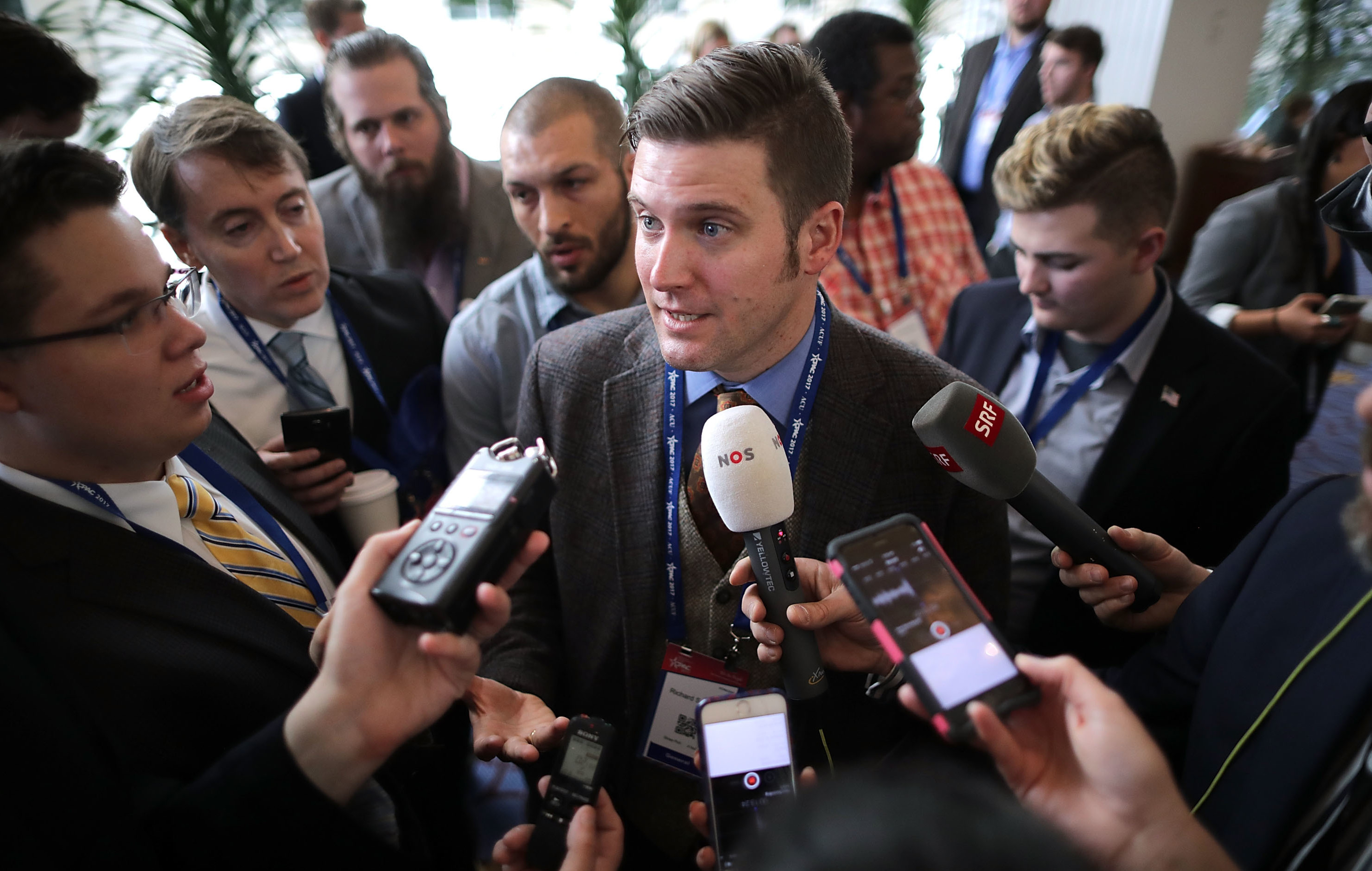 Reporters surround white nationalist Richard Spencer on Thursday at the Conservative Political Action Conference in National Harbor, Md. (Getty Images)