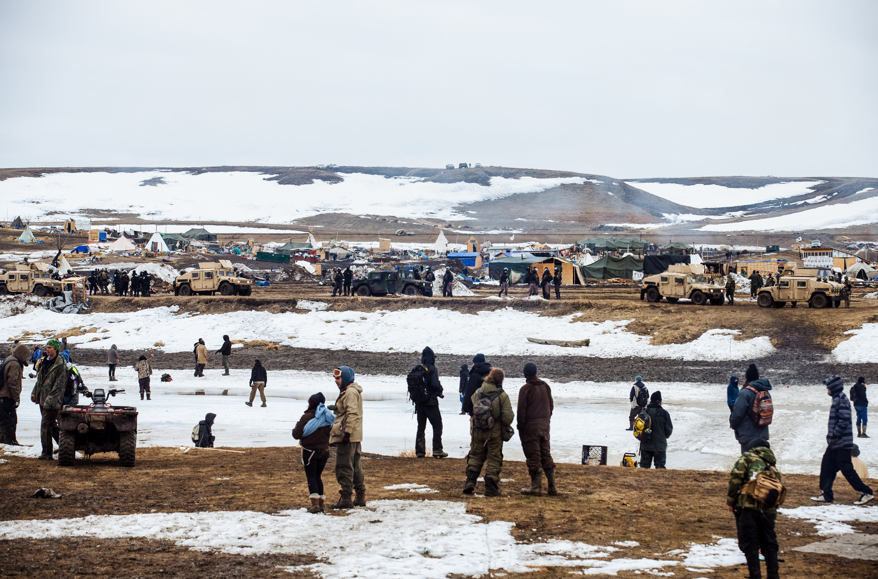 PHOTOS: The Final Hours Of A Dakota Access Pipeline Protest Camp 5 Protestors stand on the southern bank of the Cannonball River, on reservation land, as police secure the remainder of the Oceti Sakowin camp on the opposite bank.