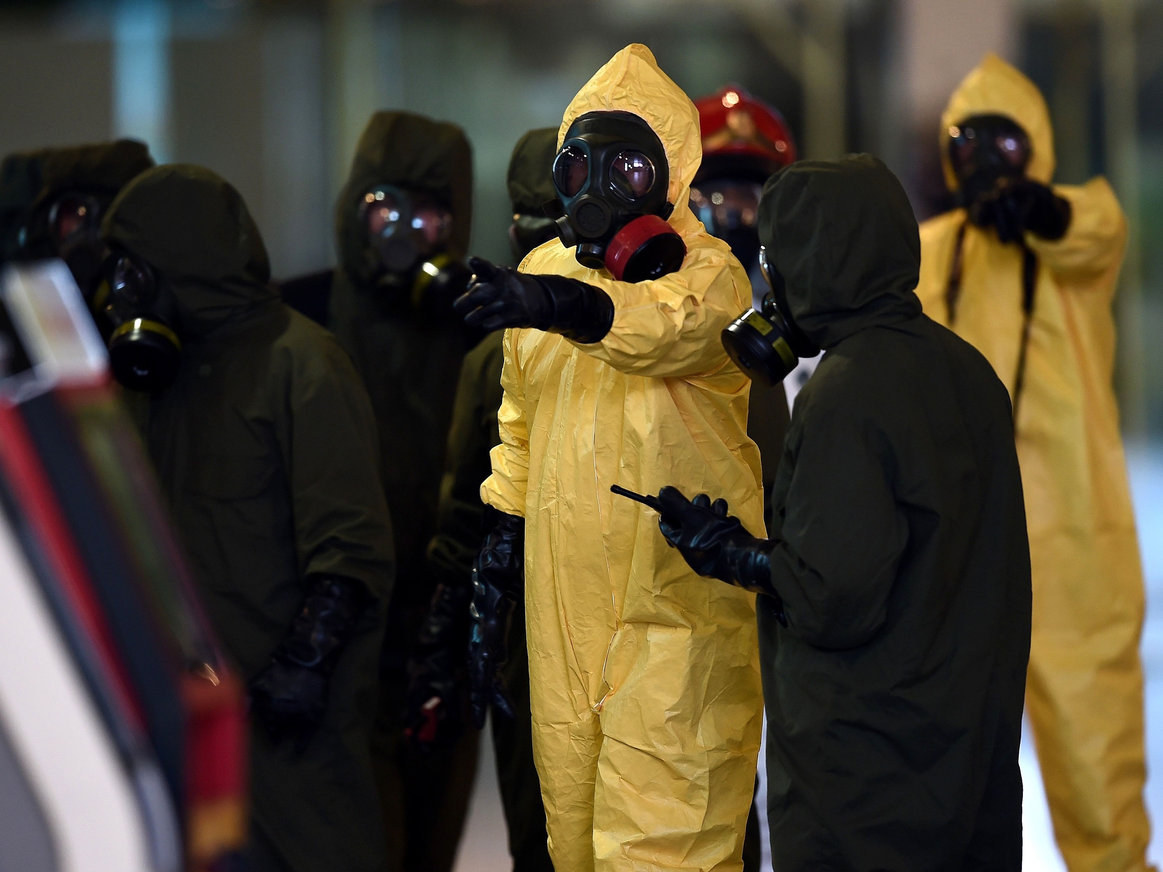 Members of Malaysia's hazardous materials team conduct a decontamination operation at the Kuala Lumpur International Airport on Sunday. (AFP/Getty Images)