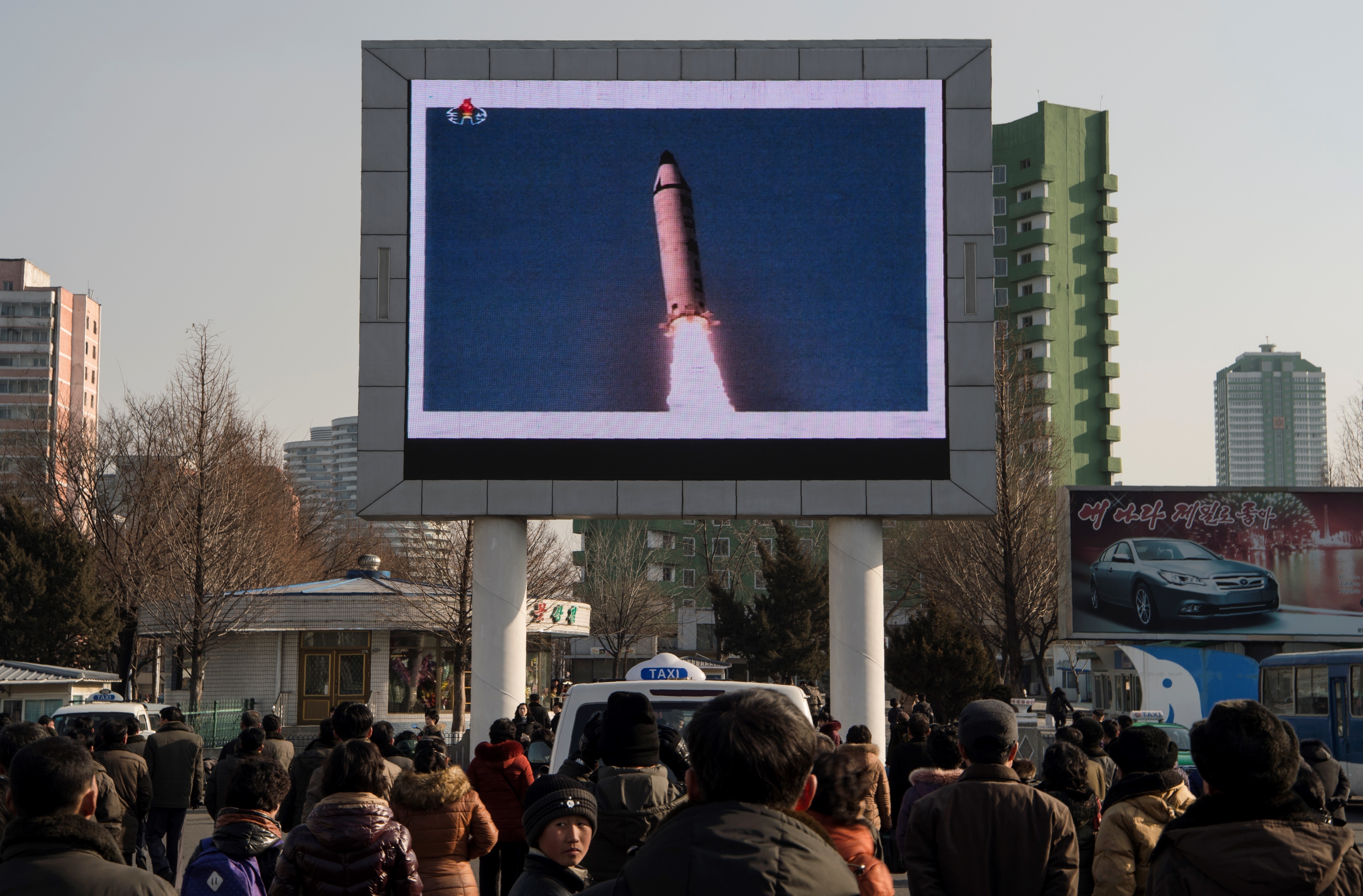On Feb. 13, people in Pyongyang watch a public broadcast regarding the Feb. 12 launch of a long-range ballistic missile at an undisclosed location — the first fired in Donald Trump's presidency. The U.N. Security Council on Feb. 13 unanimously condemned the missile test by North Korea. (AFP/Getty Images)