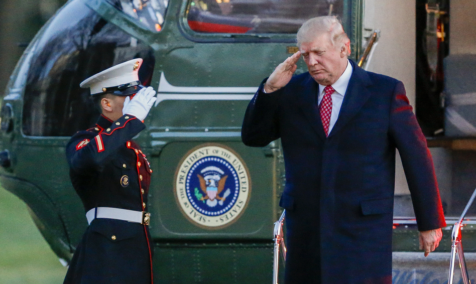 President Trump salutes as he disembarks Marine One on the South Lawn of the White House on Sunday. Trump signed a new executive order on travel and refugee resettlement on Monday. (Erik S. Lesser/Pool/Getty Images)