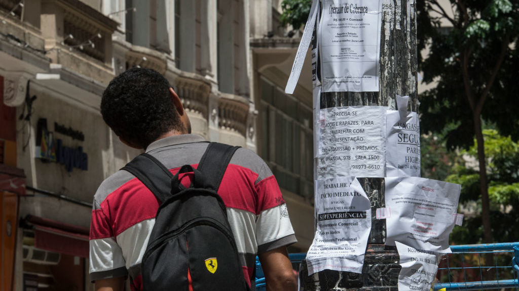a guy tests out task advertisements in January 2017, in downtown Sao Paulo. Brazil is utilizing an unemployment crisis.
