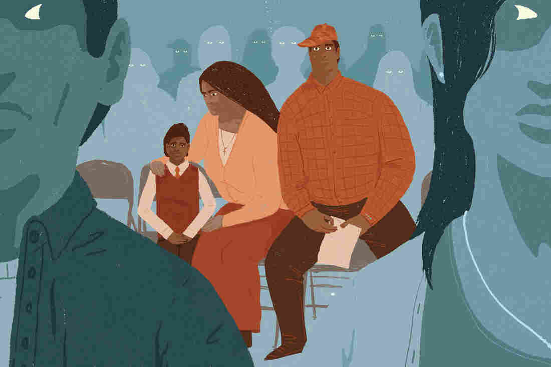 Undocumented immigrants sit in a community meeting.