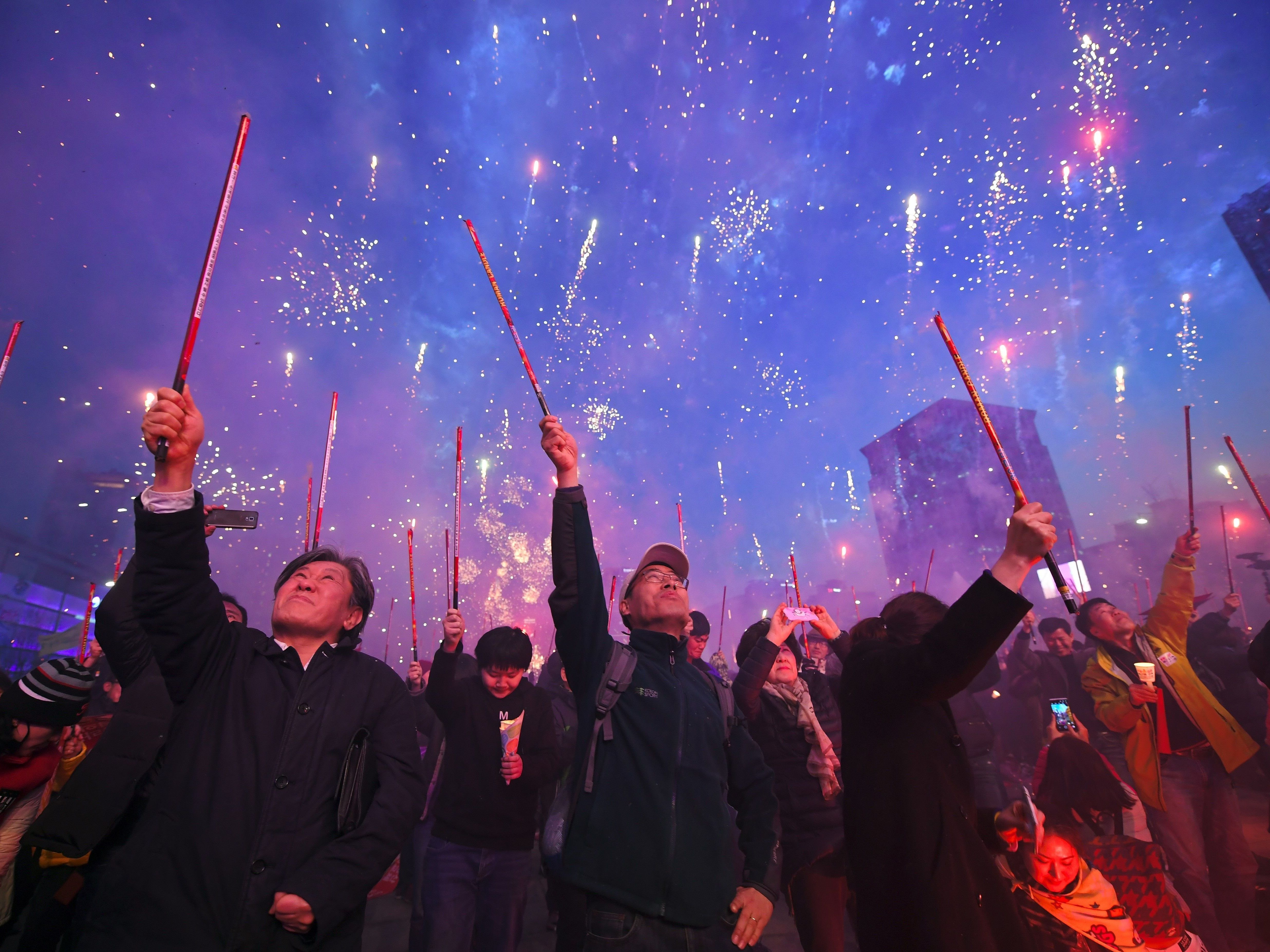 South Korean demonstrators shoot off firecrackers in Seoul on March 11, 2017 to celebrate the impeachment of Park Geun-Hye during a candlelit rally demanding the arrest of the ousted president. (AFP/Getty Images)