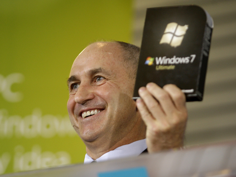 Chris Liddell, then CFO of Microsoft Corp., holds up a copy of the Windows 7 computer operating system during a rally to celebrate its release in October 2009. (Ted S. Warren/AP)