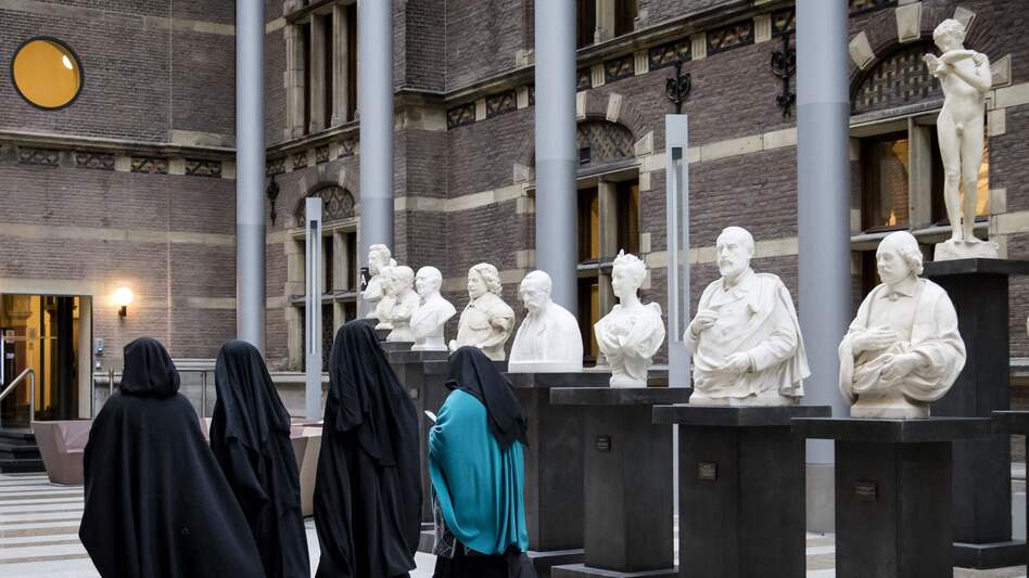 A European court has sided with employers who restrict Muslim women from wearing Islamic headscarves. Here, women wearing niqab visit the Dutch Senate last November, as restrictions on Islamic head coverings were being debated. (AFP/Getty Images)