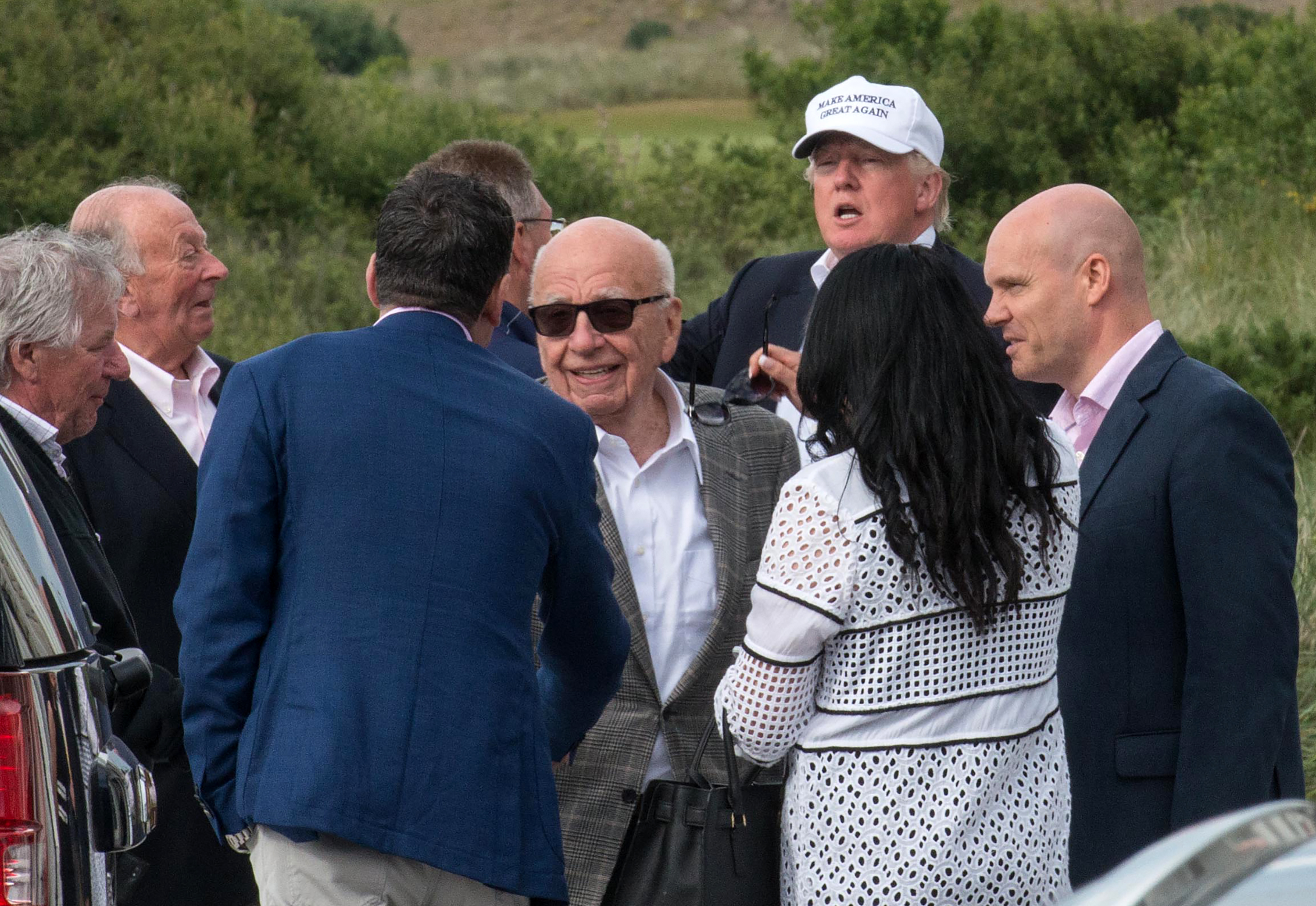 Candidate Donald Trump and media magnate Rupert Murdoch (center) at Trump International Golf Links in Aberdeen, Scotland, last June. (AFP/Getty Images)