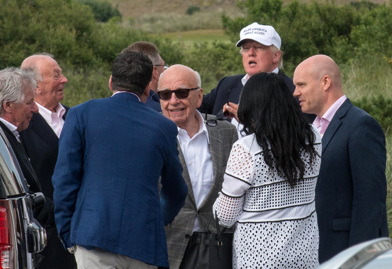 Candidate Donald Trump and media magnate Rupert Murdoch (center) at Trump International Golf Links in Aberdeen, Scotland, last June. (Michal Wachucik/AFP/Getty Images)