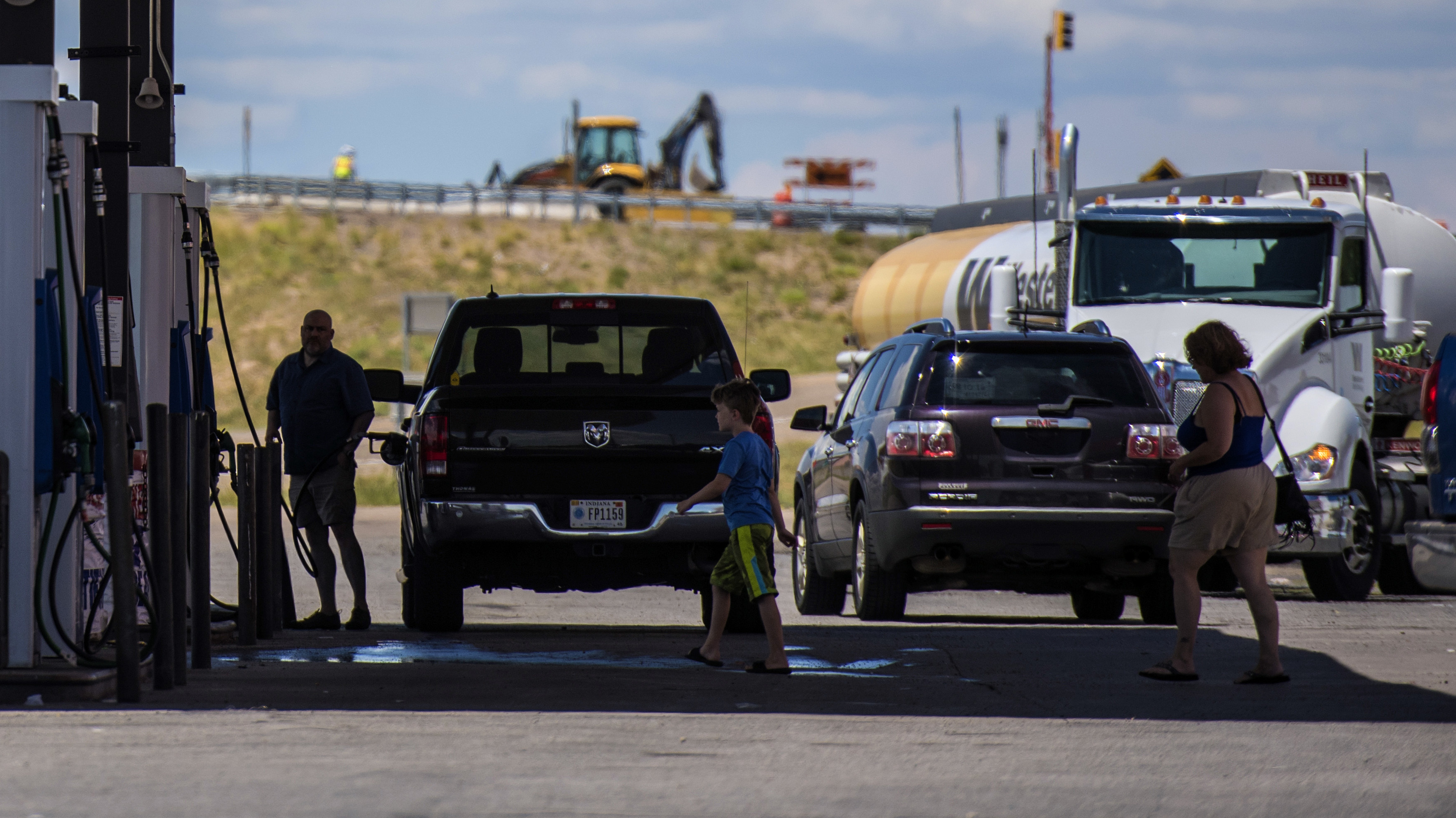 The CAFE standards that set fuel efficiency marks for the auto industry will be reopened for review, the Trump administration says. Here, vehicles refuel at a roadside gas station in New Mexico. (Bloomberg via Getty Images)