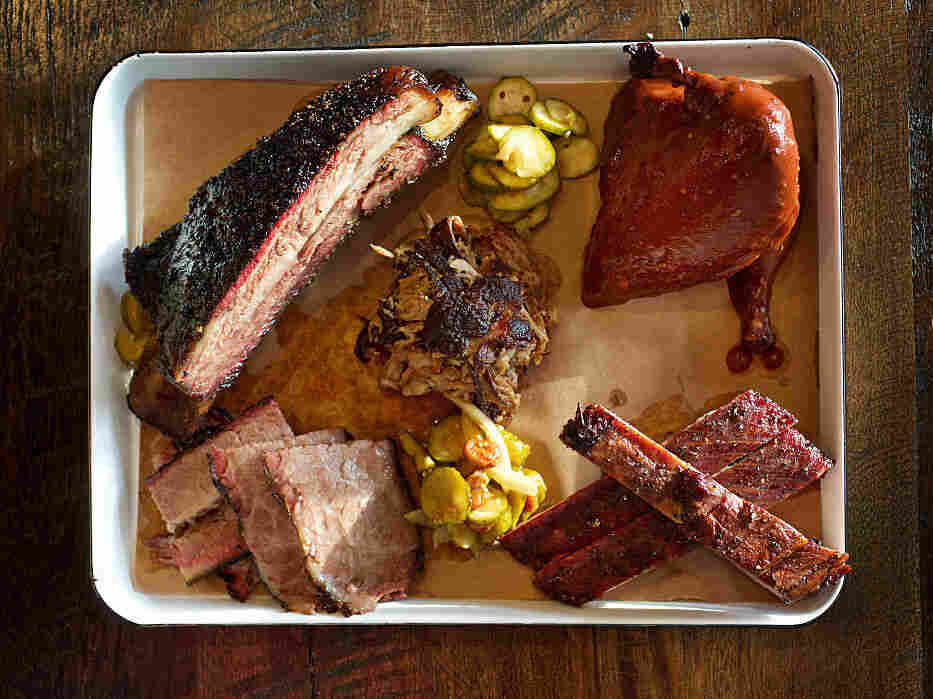 A meat platter with brisket, pulled pork, pork spare ribs, beef short ribs and chicken.