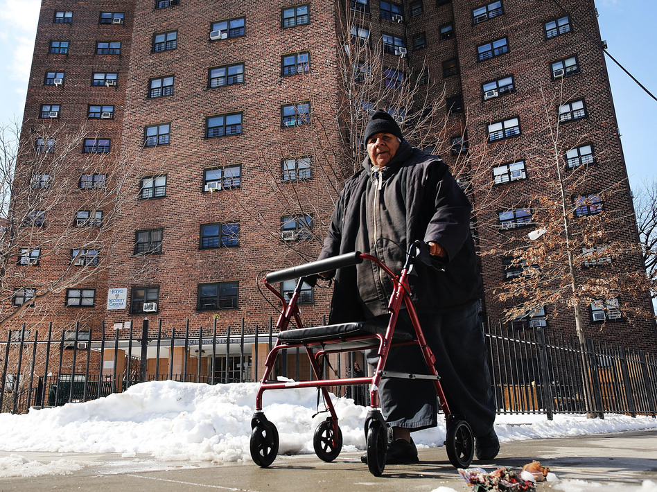 A man walks by the Farragut Houses, a public housing project in Brooklyn, N.Y. The budget blueprint President Trump released Thursday calls for the cutting of billions of dollars in funding from the Department of Housing and Urban Development. (Spencer Platt/Getty Images)