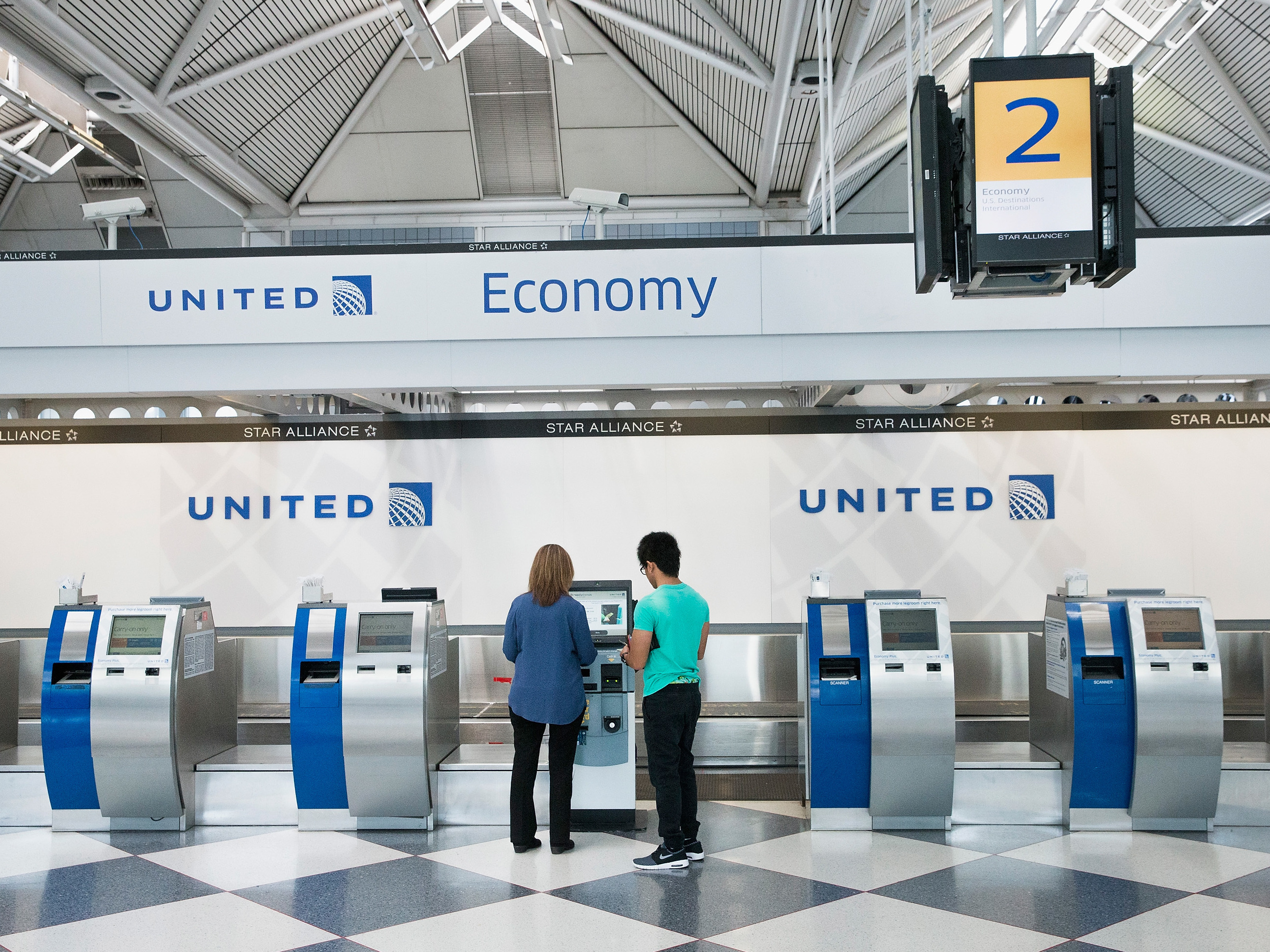 Passengers check in for flights with United Airlines at Chicago O'Hare International Airport. United, American and Delta now offer no-frills &quot;basic economy&quot; fares. (Getty Images)