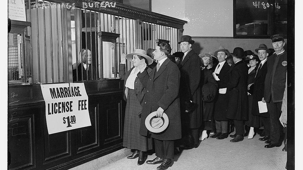 Couples stand in line to obtain their marriage licenses in this photograph, taken sometime between 1915 and 1920. The 1907 Expatriation Act would have affected people trying to get married during this time period — though the couples depicted in this photo were not necessarily affected by the Expatriation Act.