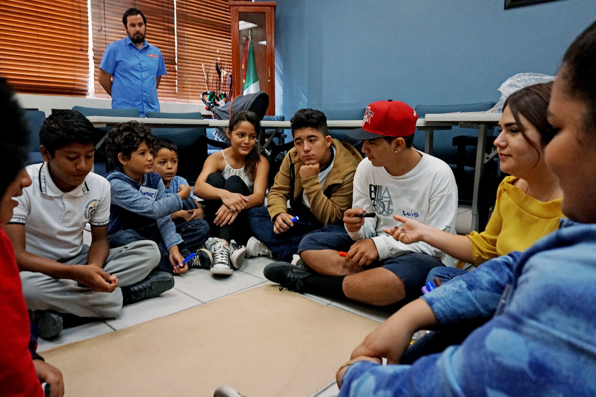 New arrivals to Mexico discuss challenges during a class at the Tijuana Education Department. (Sandy Huffaker for NPR)