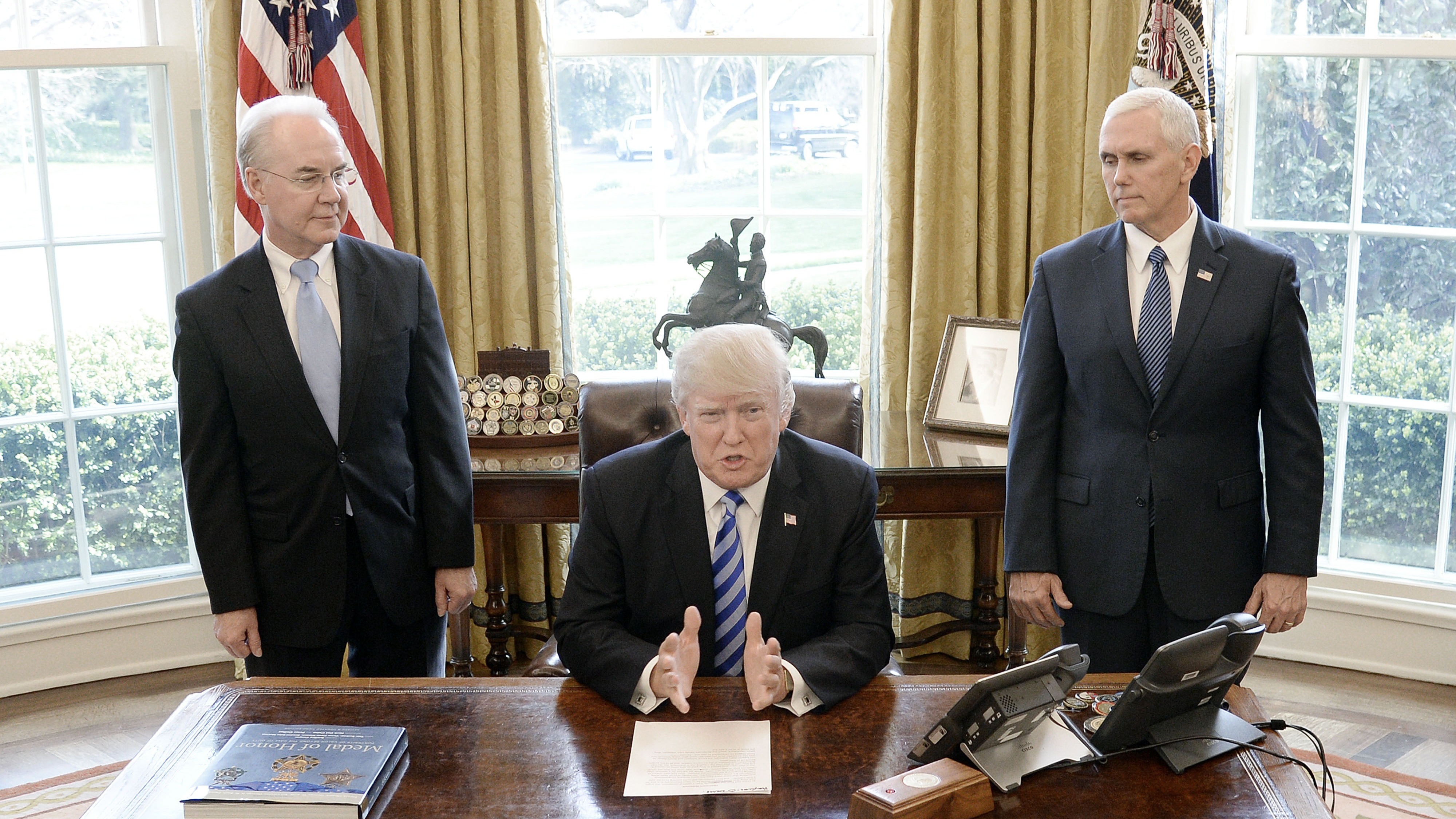 Flanked by HHS Secretary Tom Price and Vice President Pence, Donald Trump reacts after Republicans abruptly pulled their health care bill from the House floor. (Getty Images)