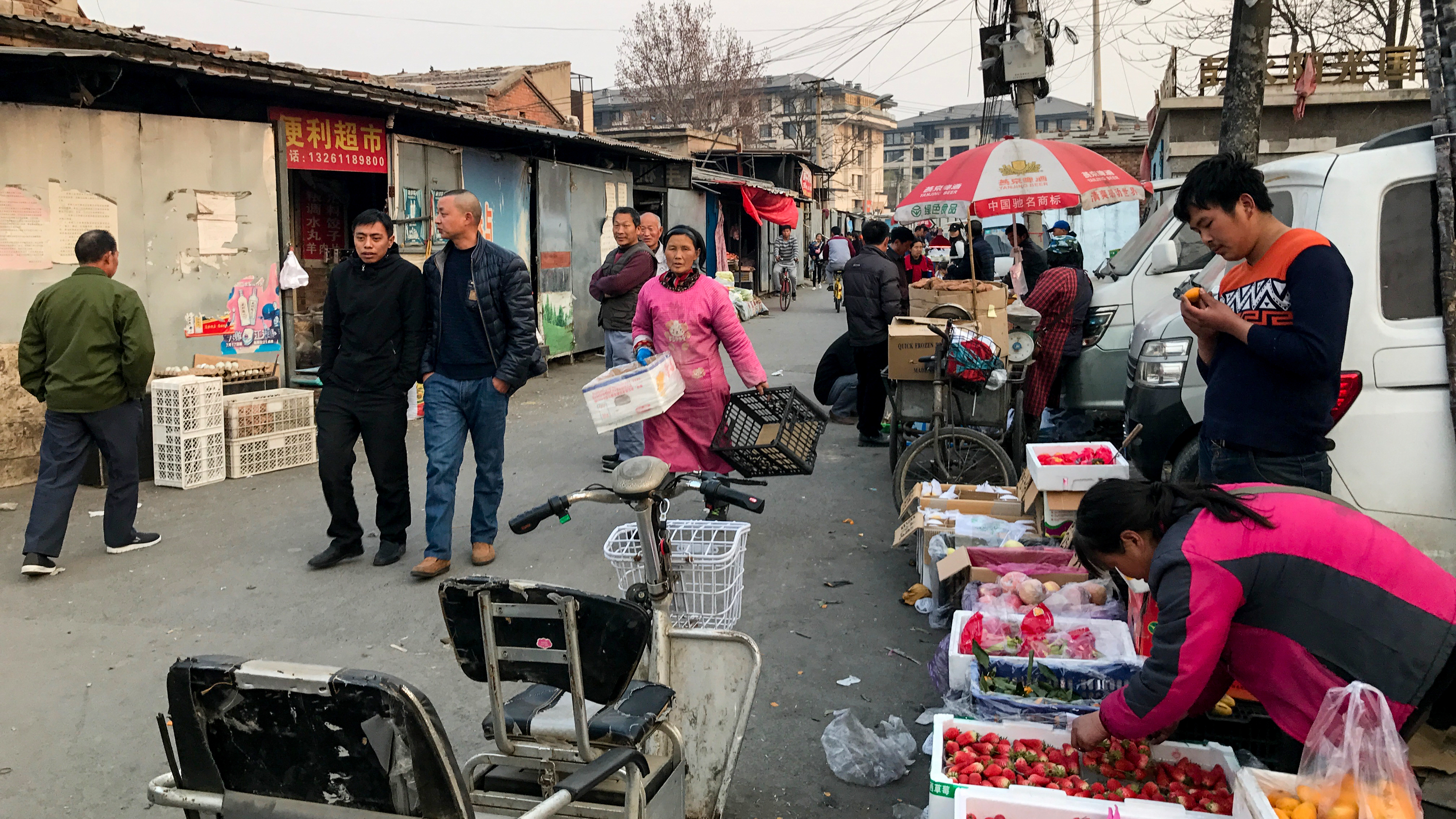 A street scene in China with cars and buildings.