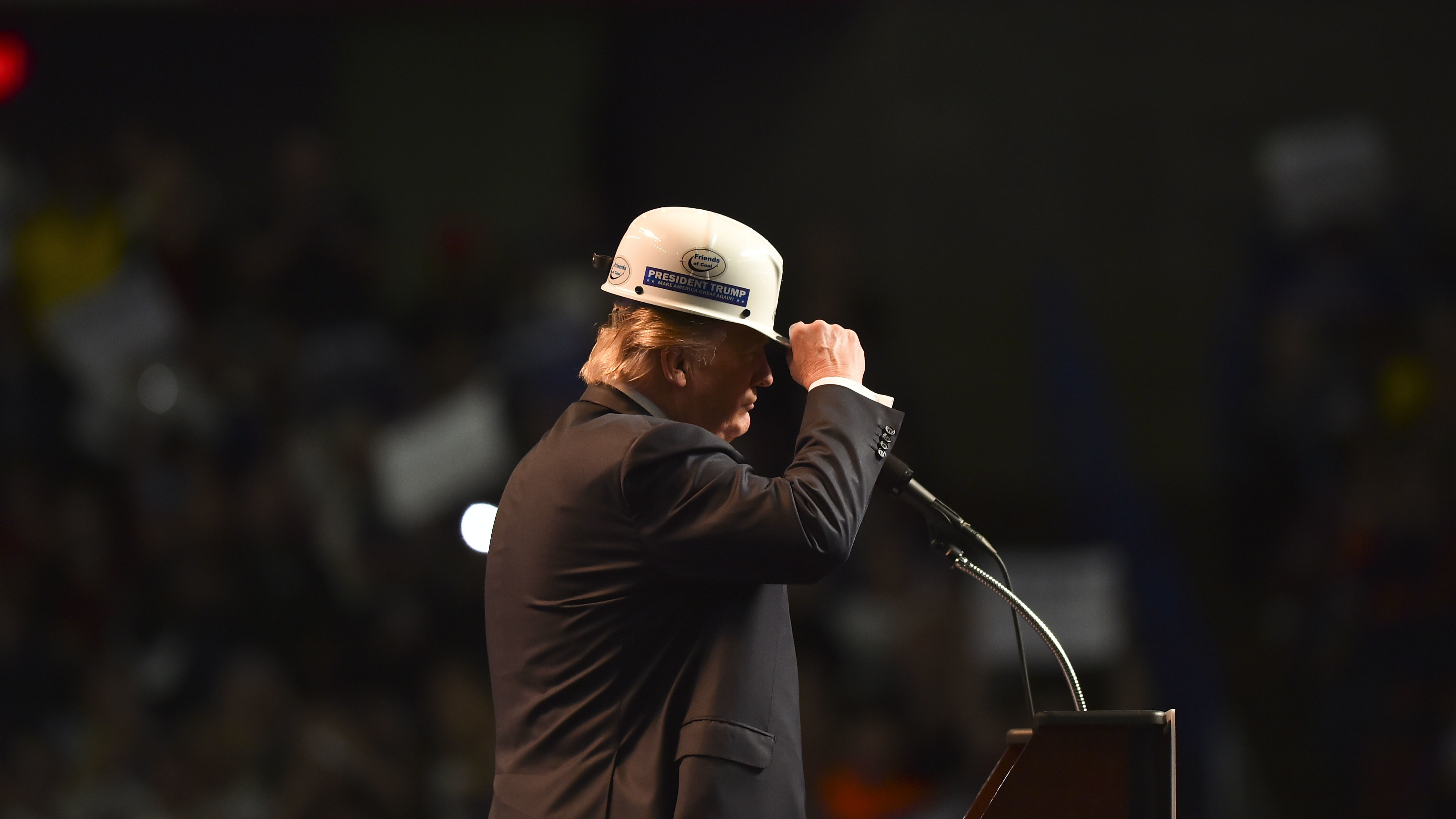 Donald Trump wears a coal miner's protective hat while addressing supporters at a rally in Charleston, W.V., last May. (The Washington Post via Getty Images)