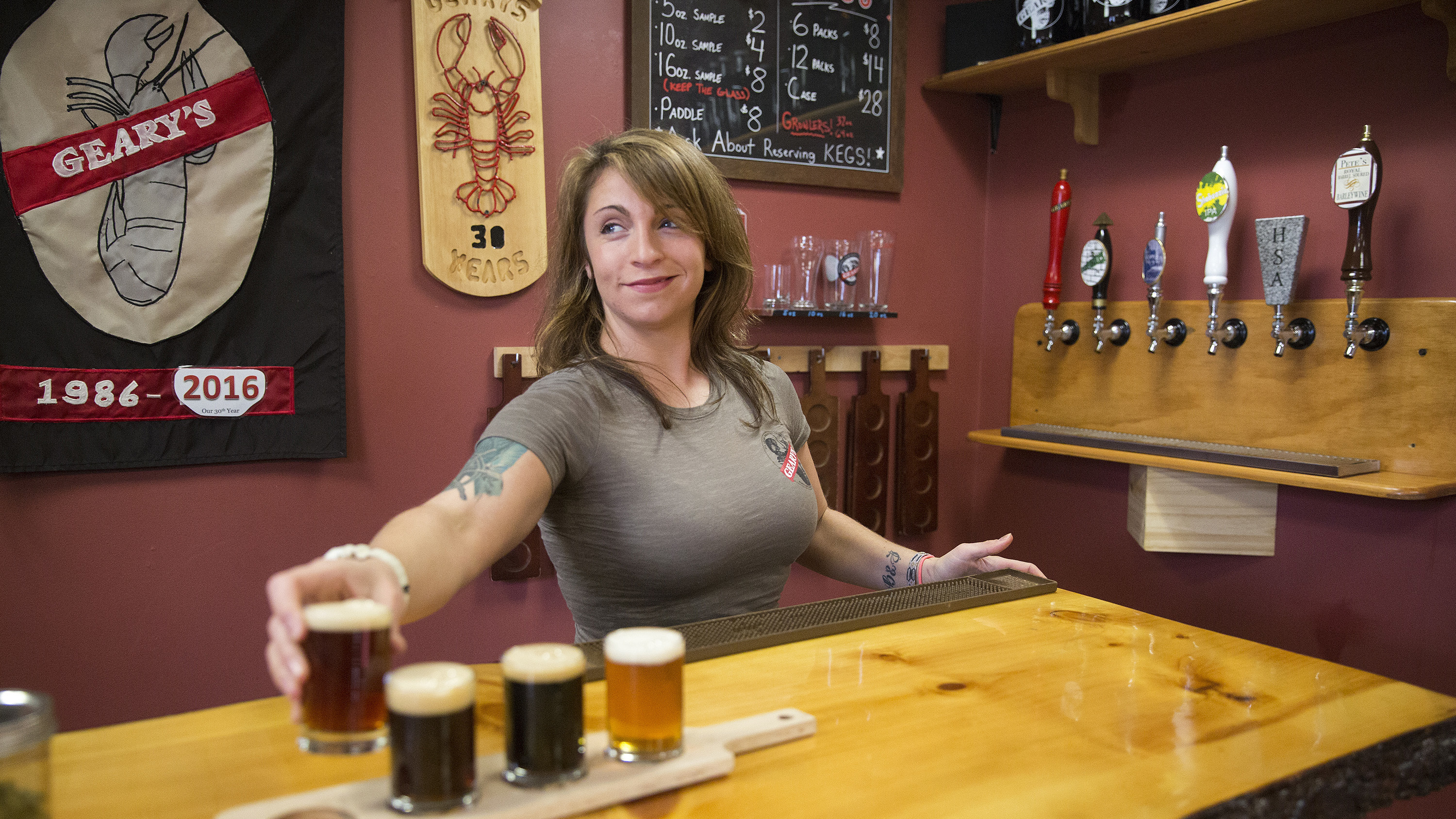 Craft breweries now account for 5,234 of 5,301 U.S. beer makers, according to an industry group's annual tally. Here, Danielle Coons, the tasting room ambassador at D.L. Geary Brewing Co.<strong> </strong>serves a beer in Portland, Maine, last November. (Portland Press Herald via Getty Images)