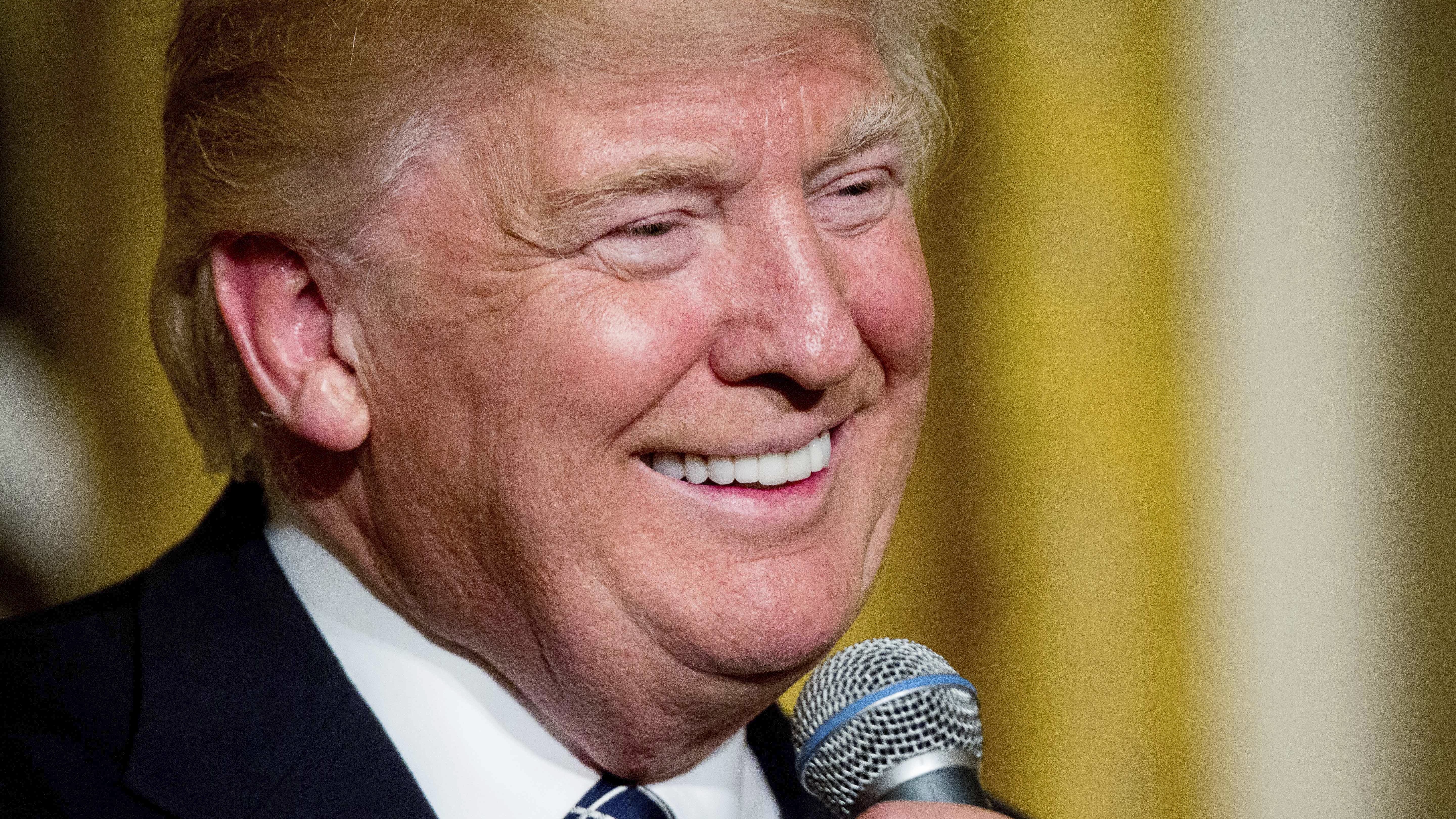 President Trump speaks at a reception for senators and their spouses in the East Room of the White House on Tuesday.