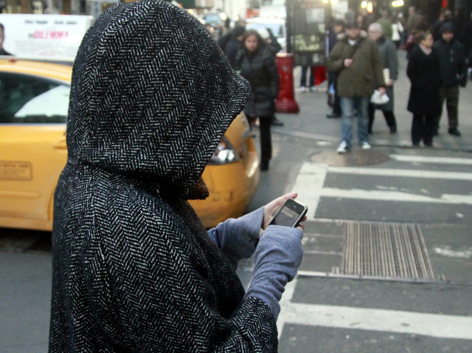 Drivers distracted by their devices are a well-documented, rising cause of traffic crashes, but there are a growing number of pedestrians, too, who can become oblivious to traffic around them. (Bebeto Matthews/AP)