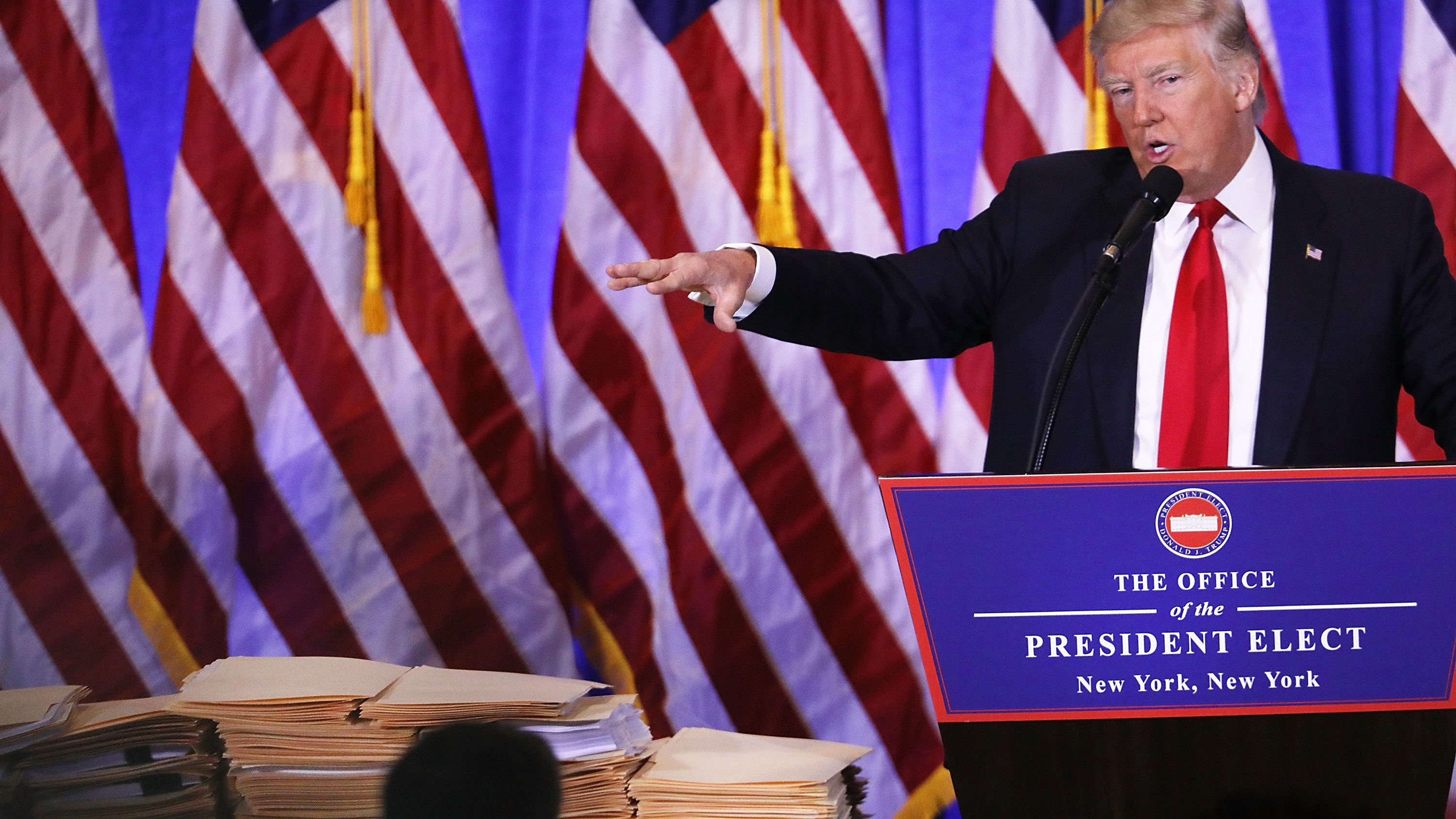 At a Jan. 11 news conference at Trump Tower on in New York City, President-elect Trump gestures at a stack of folders that he said contained documentation separating him from his businesses. That revocable trust was modified about a month later to let Trump withdraw from it at any time, ProPublica reports. (Getty Images)