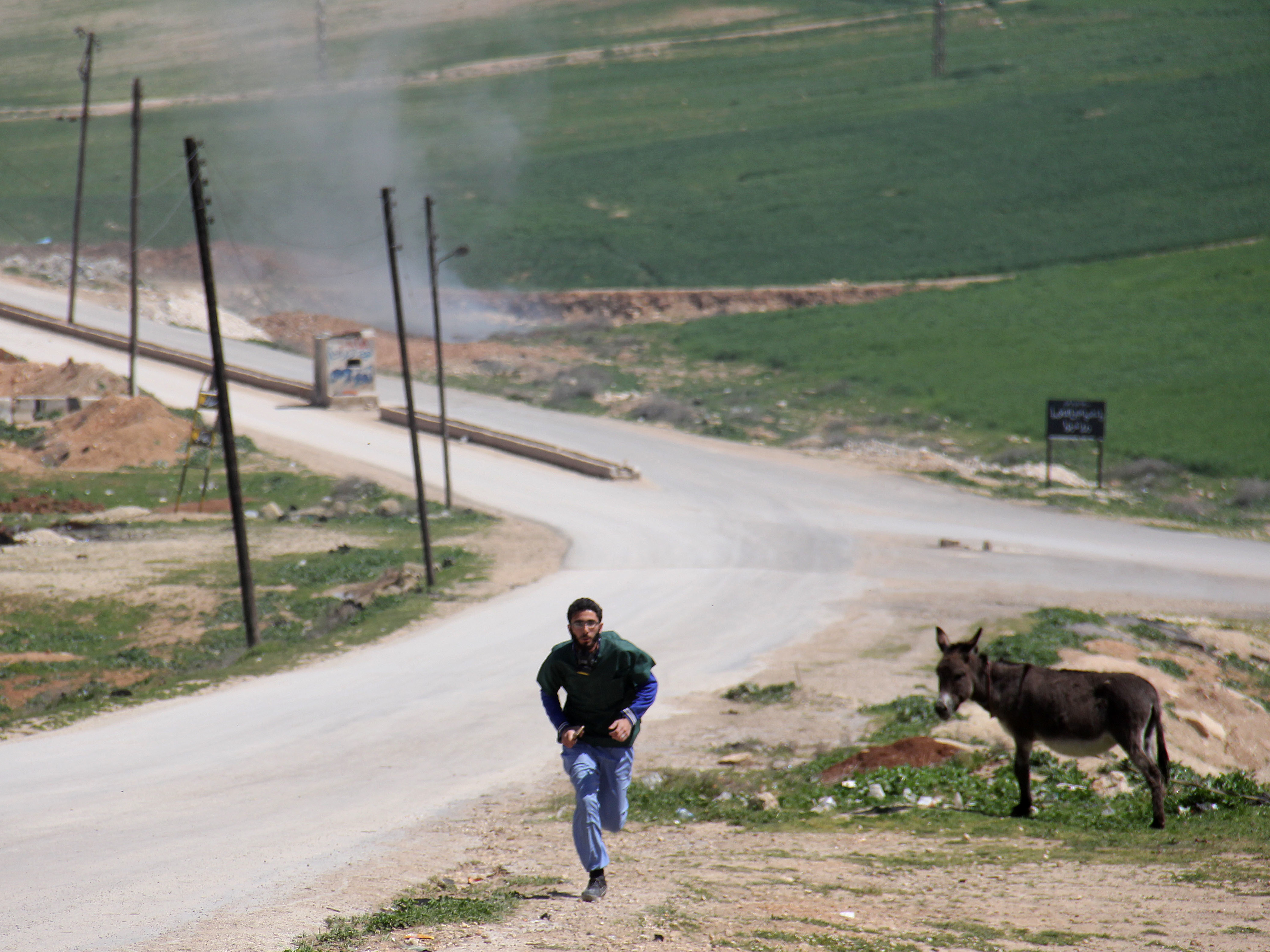 A Syrian medic runs for cover during airstrikes that hit the rebel-held town of Khan Sheikhun. A hospital in northwestern Syria also was hit as doctors inside treated victims of a suspected chemical attack.
(Omar Haj Kadour/AFP/Getty Images)