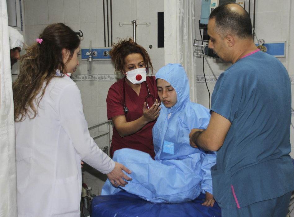 Medics at a local hospital in Hatay, Turkey, treat a victim of an attack across the border in Idlib, Syria, that experts suspect may have involved a powerful chemical weapon. (IHA via AP)