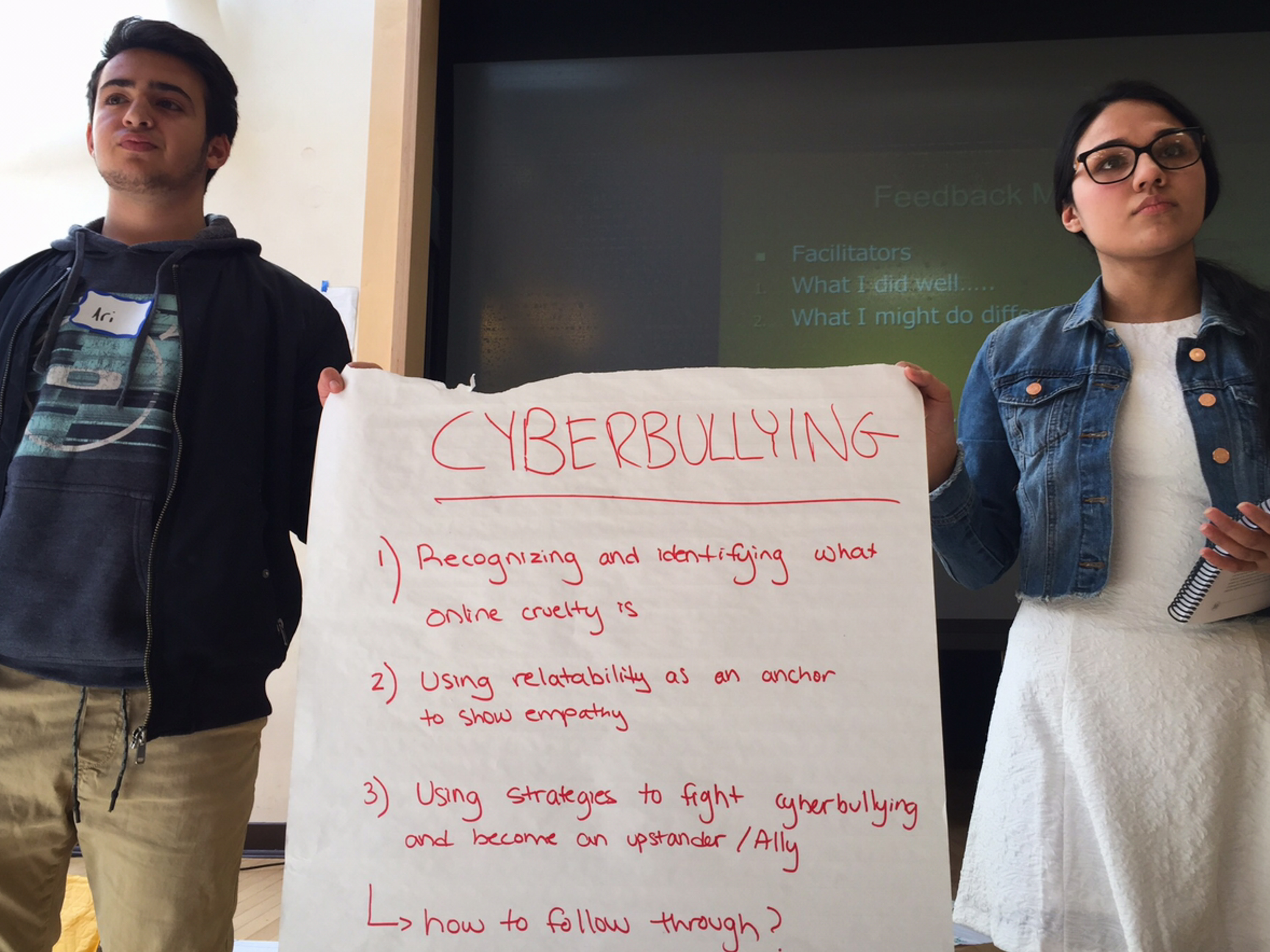 Brookline High School students Ari Lazowski (left) and Iman Khan practice presenting an exercise on cyberbullying.
(Tovia Smith/NPR)