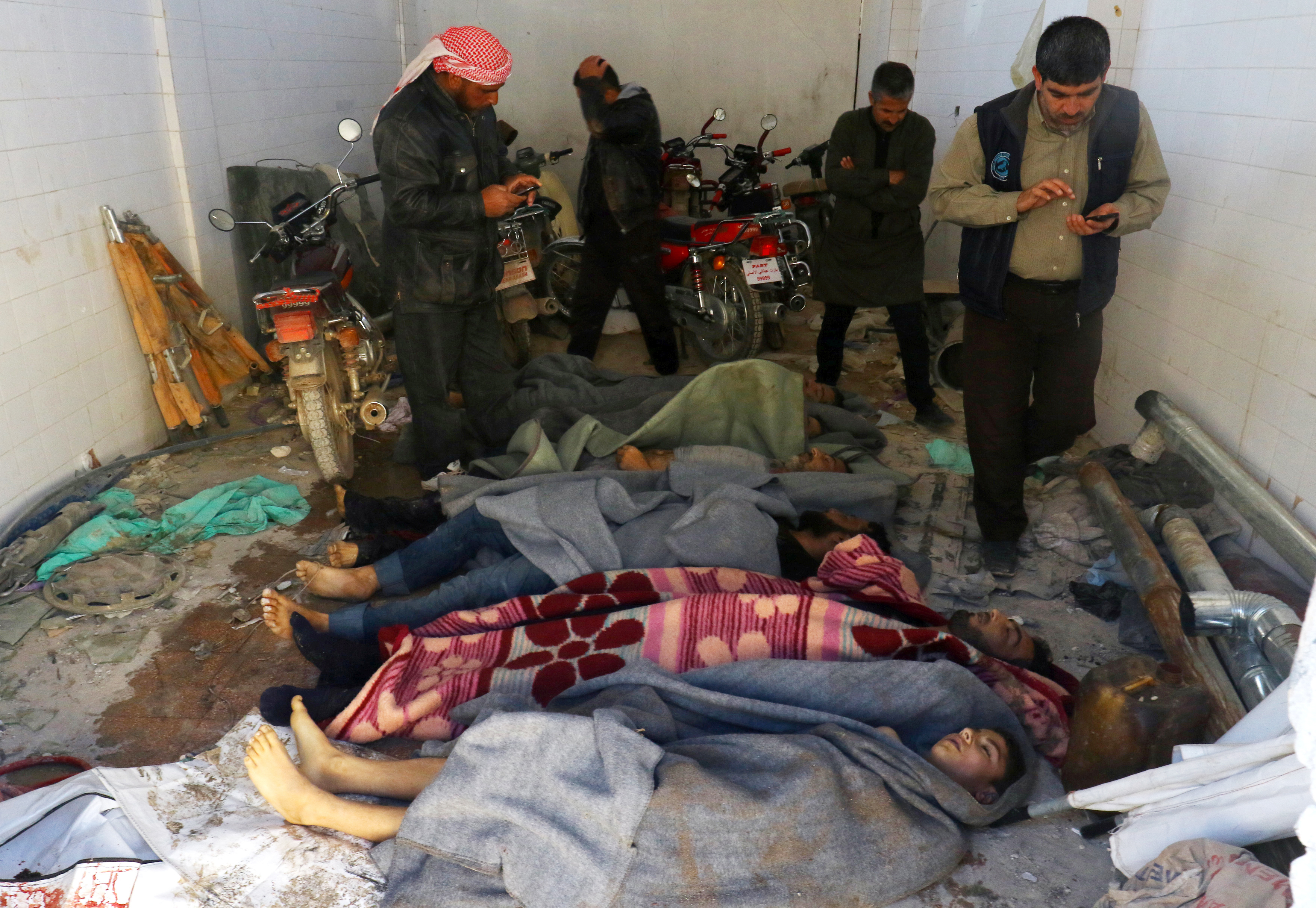 Bodies are wrapped in blankets after a suspected chemical attack in the town of Khan Shaykhun on Tuesday.
(Ammar Abdullah/Reuters)