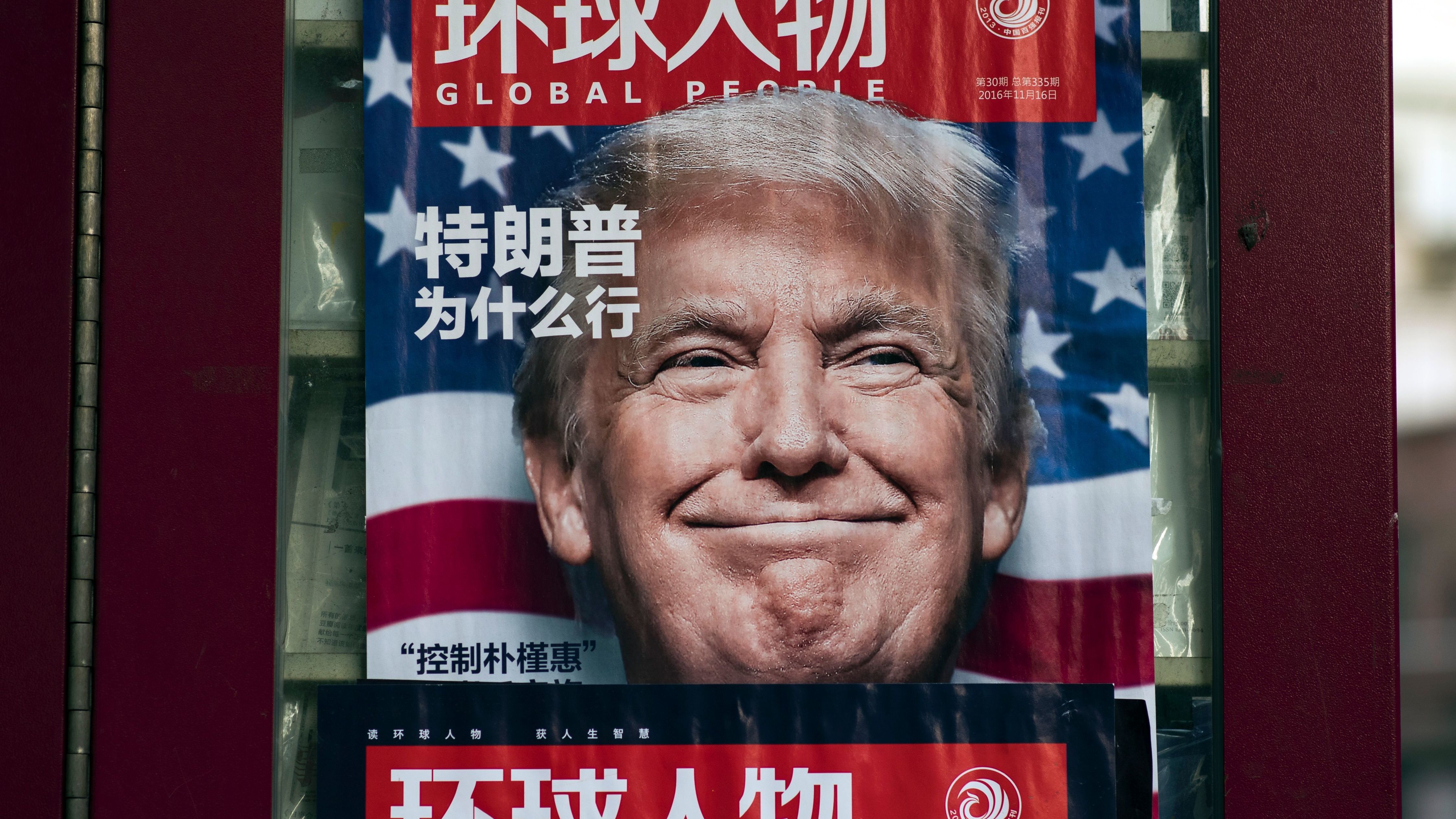 This picture taken on Dec. 14, 2016, at a news stand in Shanghai shows an advertisement for a magazine featuring Donald Trump, who would soon take office as president, on the cover. (AFP/Getty Images)
