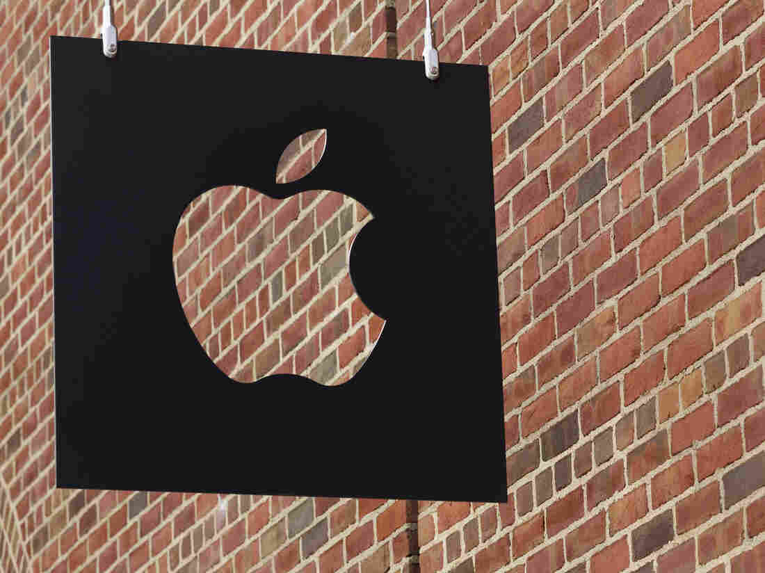 The Apple logo hangs in front of an Apple Store in Brooklyn, N.Y.