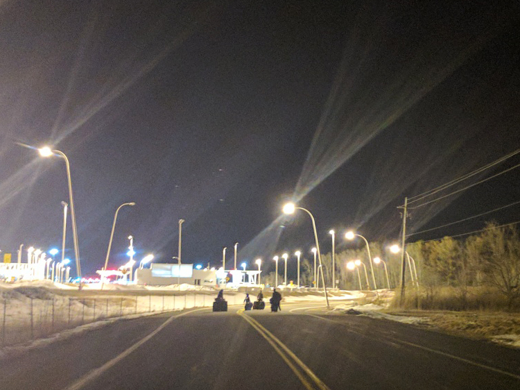 Amal and her three sons walk toward the Canadian border.
(Ashley Cleek for NPR)