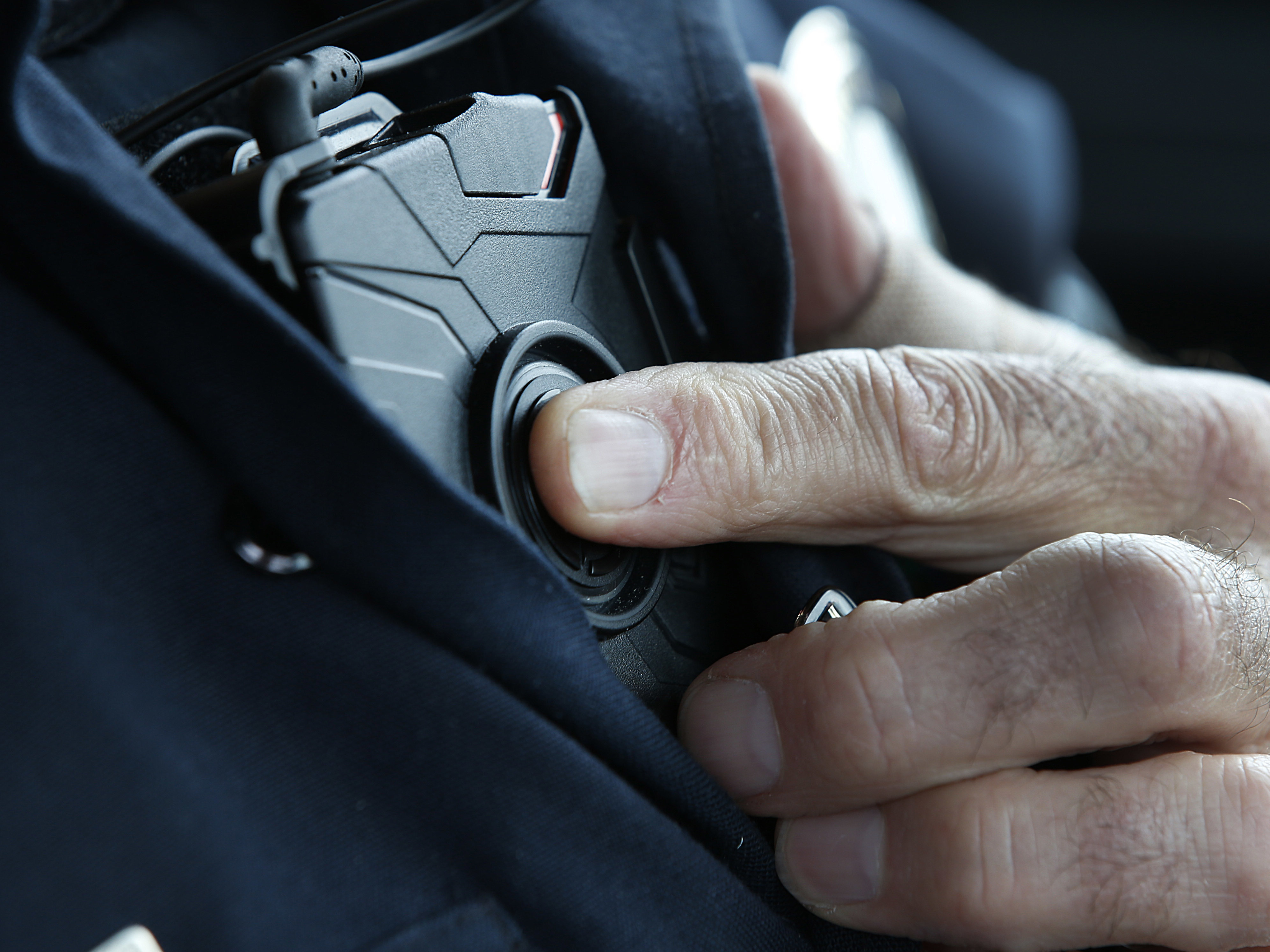 A patrol officer in West Valley City, Utah, starts a body camera recording by pressing a button on his chest in March 2015. The West Valley City Police Department issued 190 Axon Flex body cameras for all its sworn officers to wear. (Getty Images)