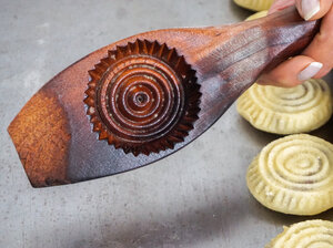 Image: Traditionally carved wooden molds are used to give shape and form to the maamoul cookies.