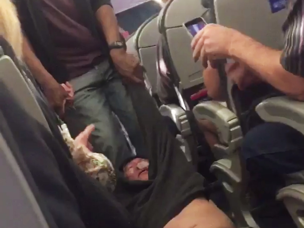 A screenshot of video showing a passenger forcibly removed from a United Airlines flight from Chicago to Louisville, Ky., on Sunday. (Screenshot by NPR)