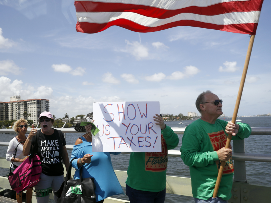 Protesters walk during a rally to encourage the release of President Donald Trump's tax returns on Saturday, April 15, 2017, in Palm Beach, Fla. (Alex Brandon/AP)